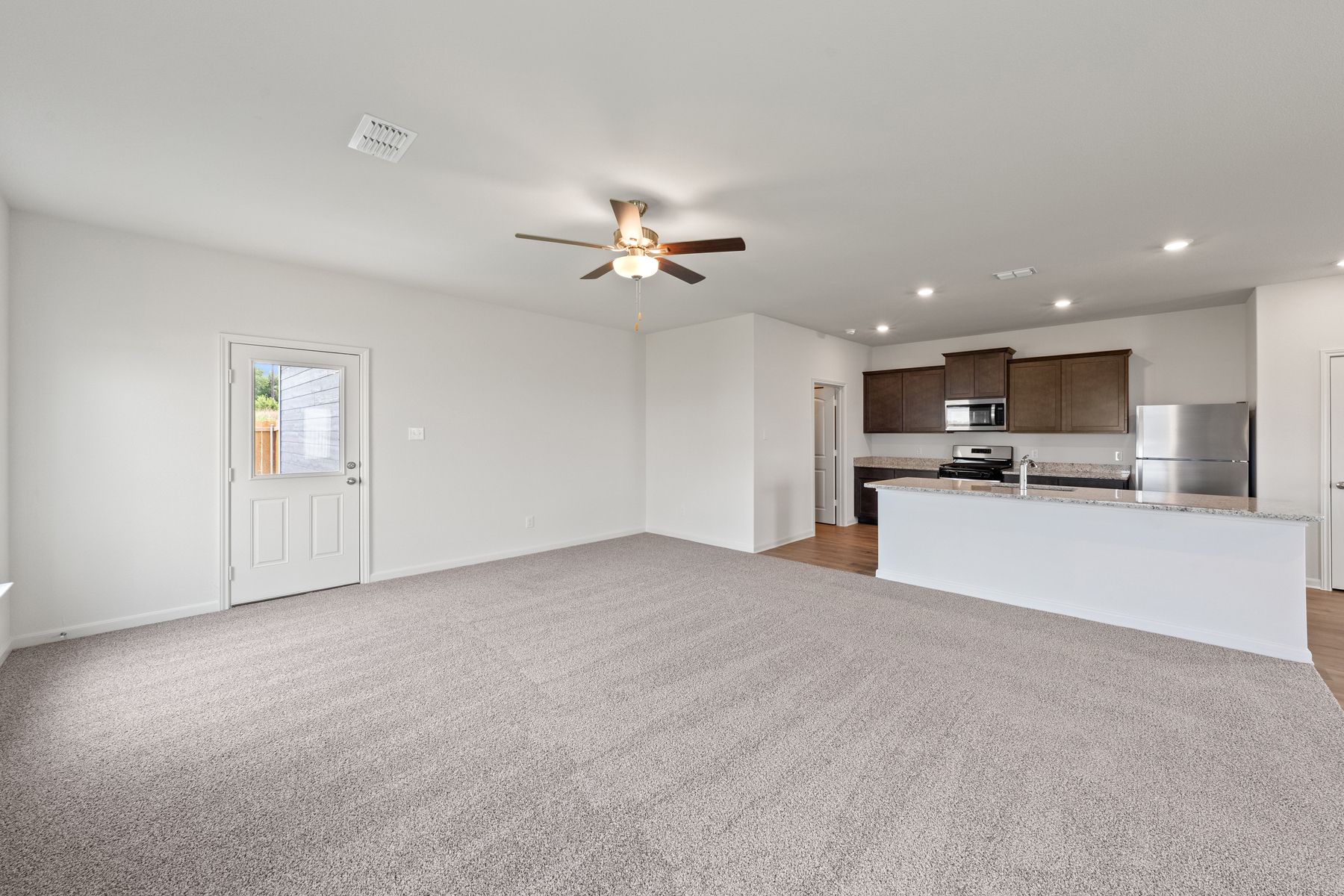The open-concept layout of this floor plan has the kitchen, family room and dining room sitting next to one another.