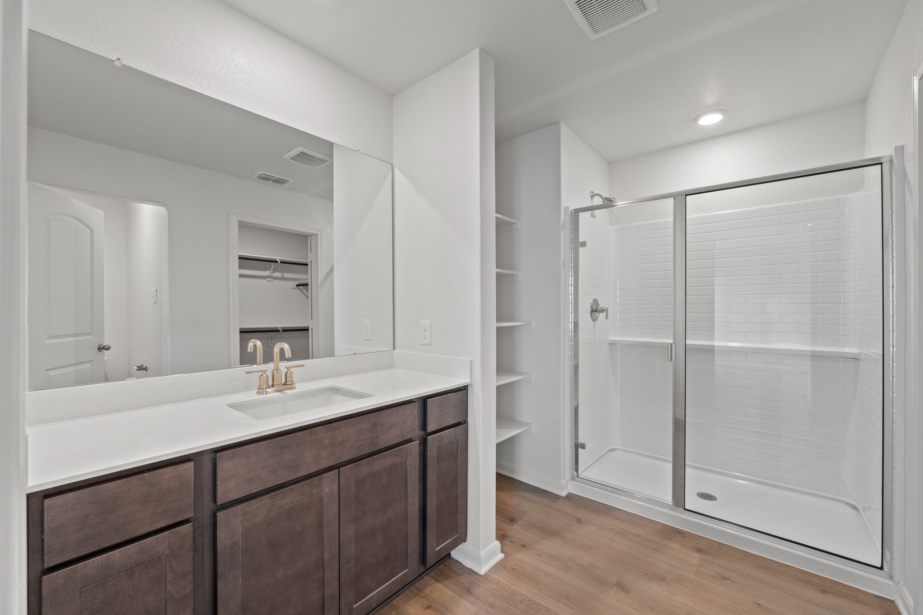 The master bathroom has a large glass, walk-in shower.