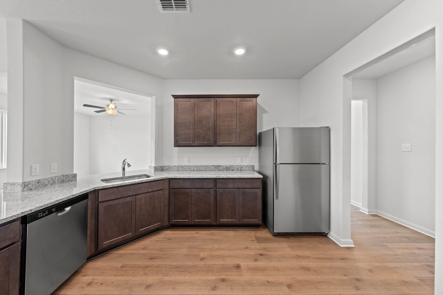 The kitchen has gorgeous wood cabinetry.