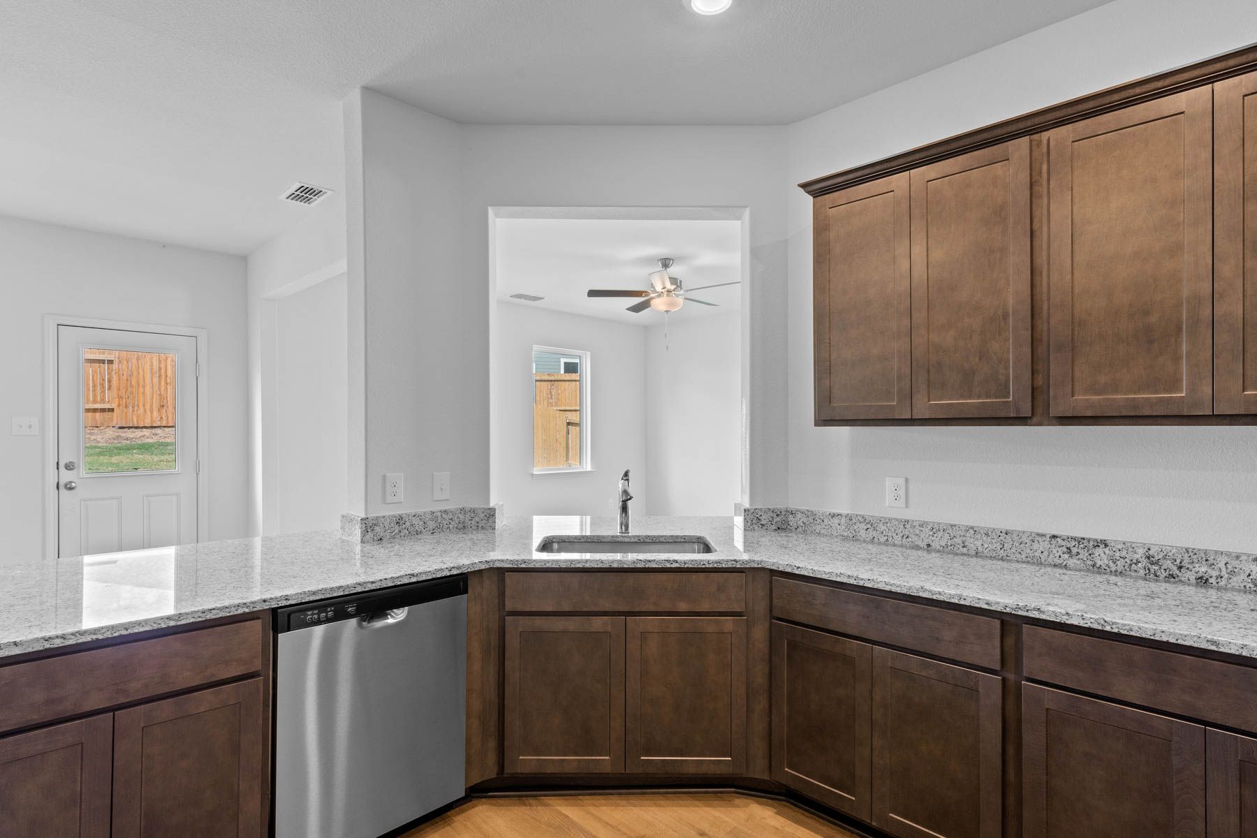 The kitchen has a window over the sink that looks out into the family room.