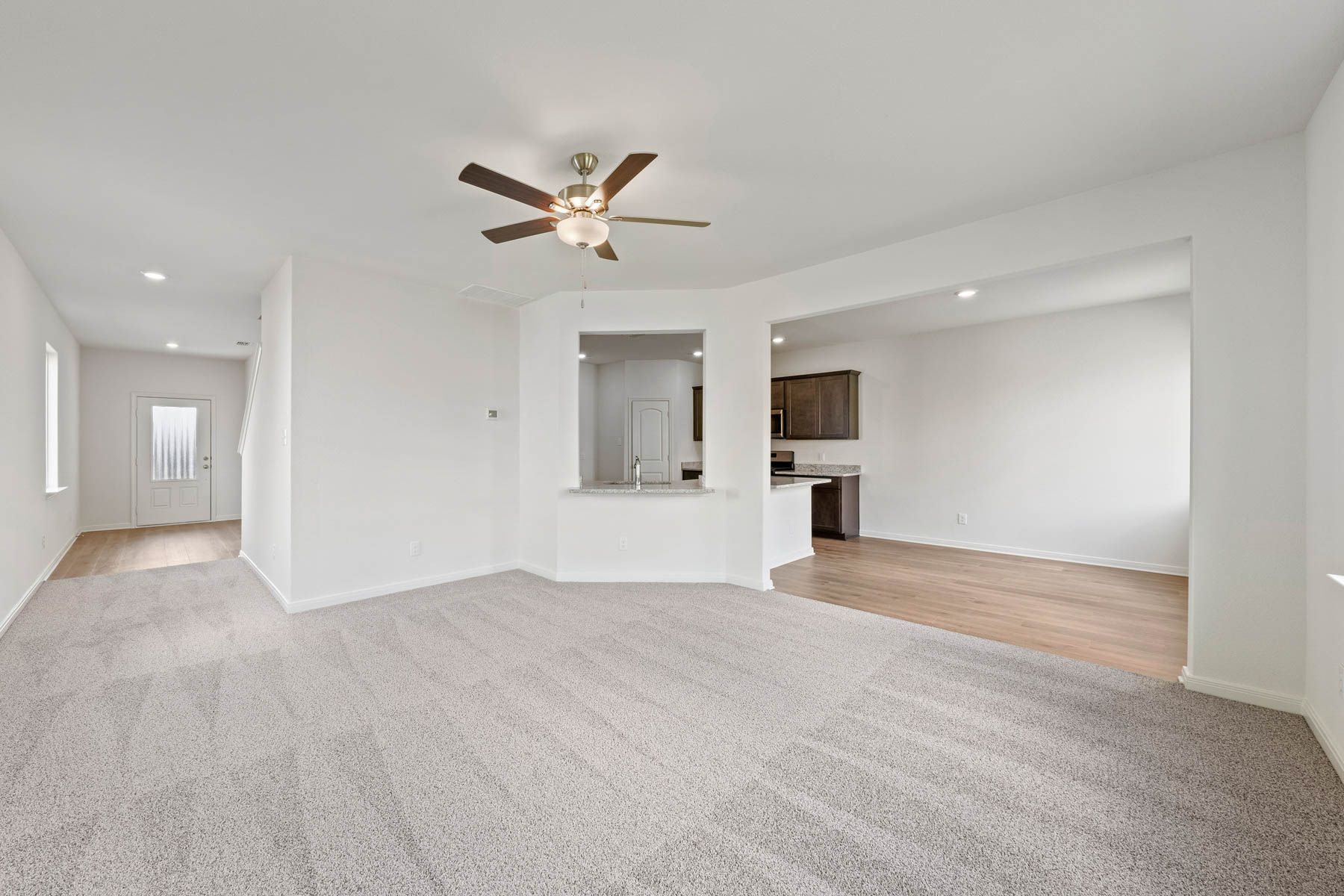 The open-concept layout of this floor plan has the kitchen, family room and dining room sitting next to one another.