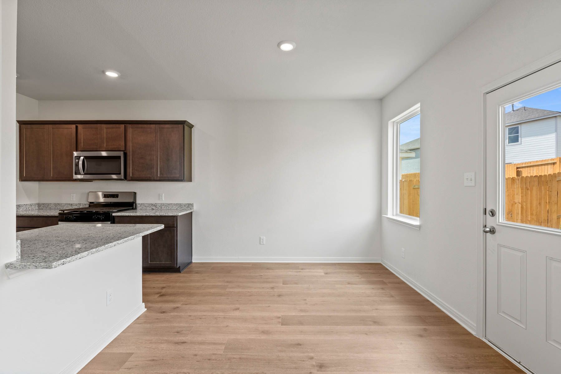 The dining room sits right off of the kitchen and has a large window.
