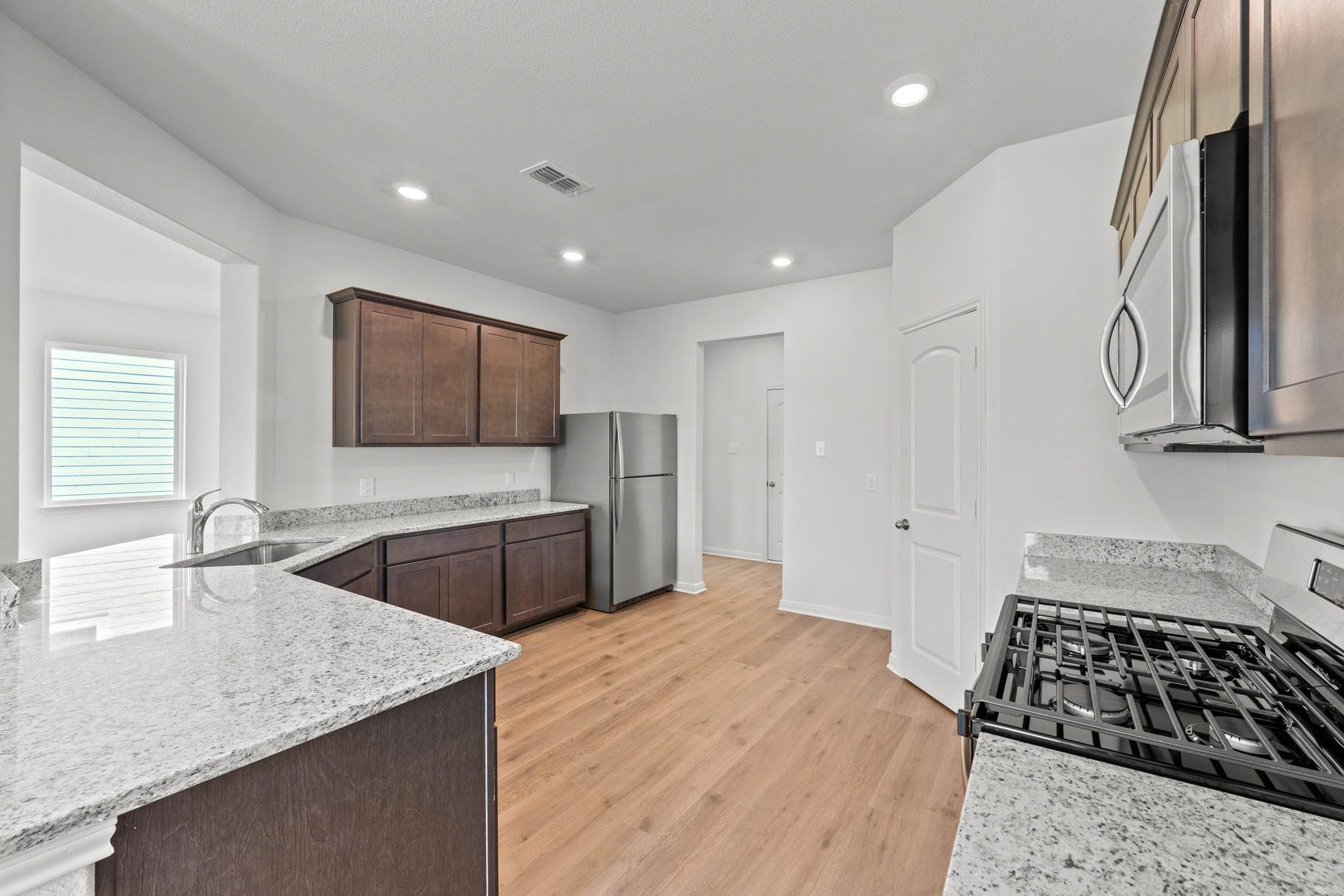 The spacious kitchen has upgraded features that make cooking and cleaning more enjoyable.
