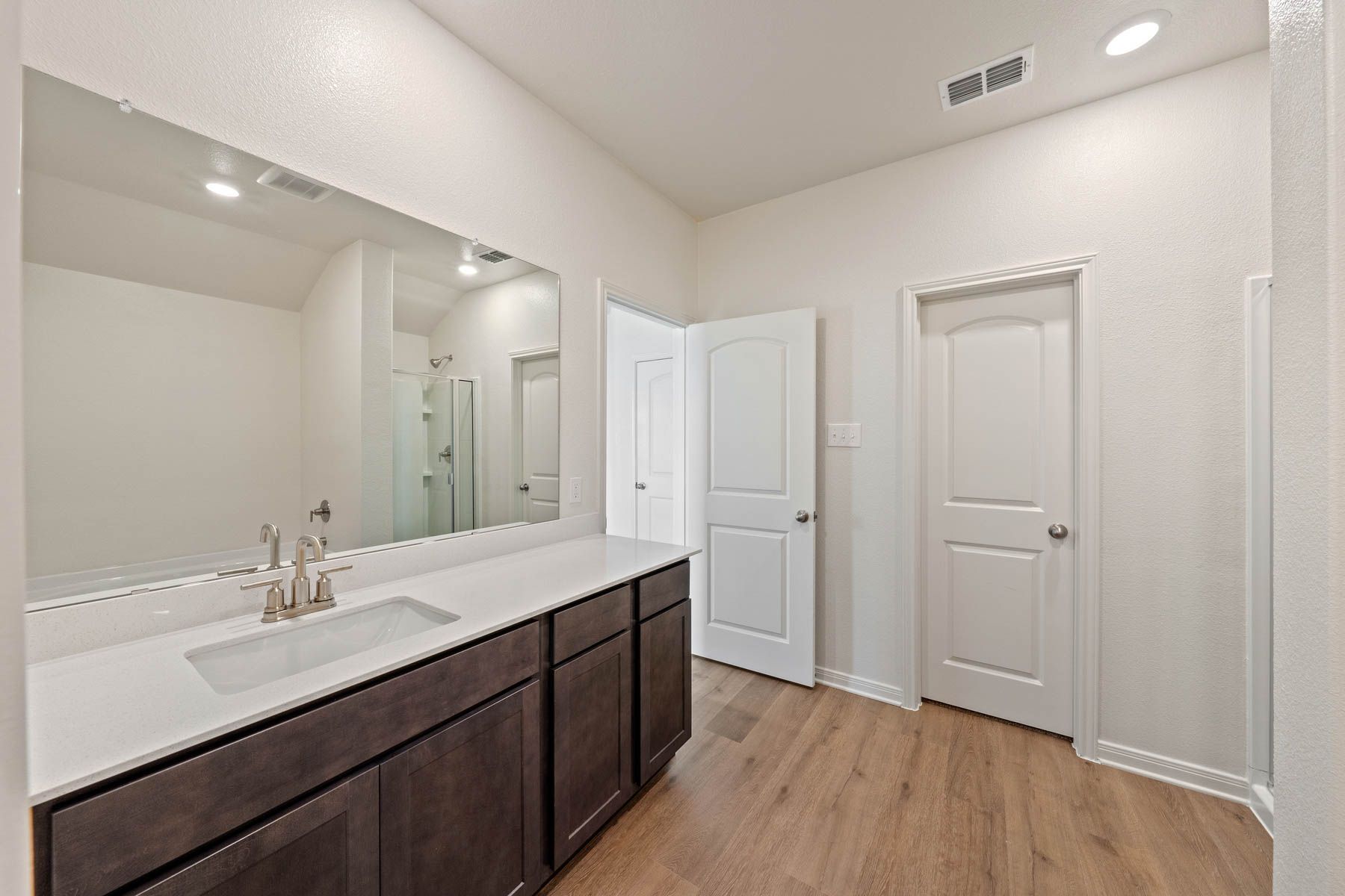 The master bathroom has a large vanity space.