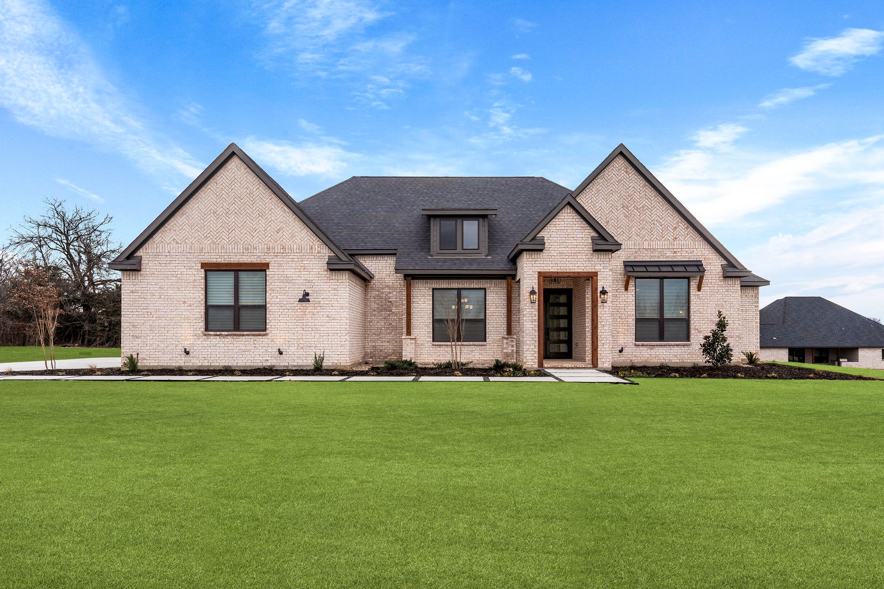 The Bradley II is a beautiful, one-story brick home with wood accents.