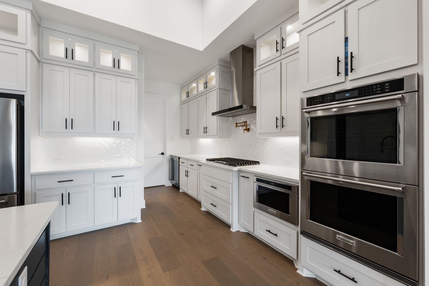 The kitchen has goregous white tile backsplash.