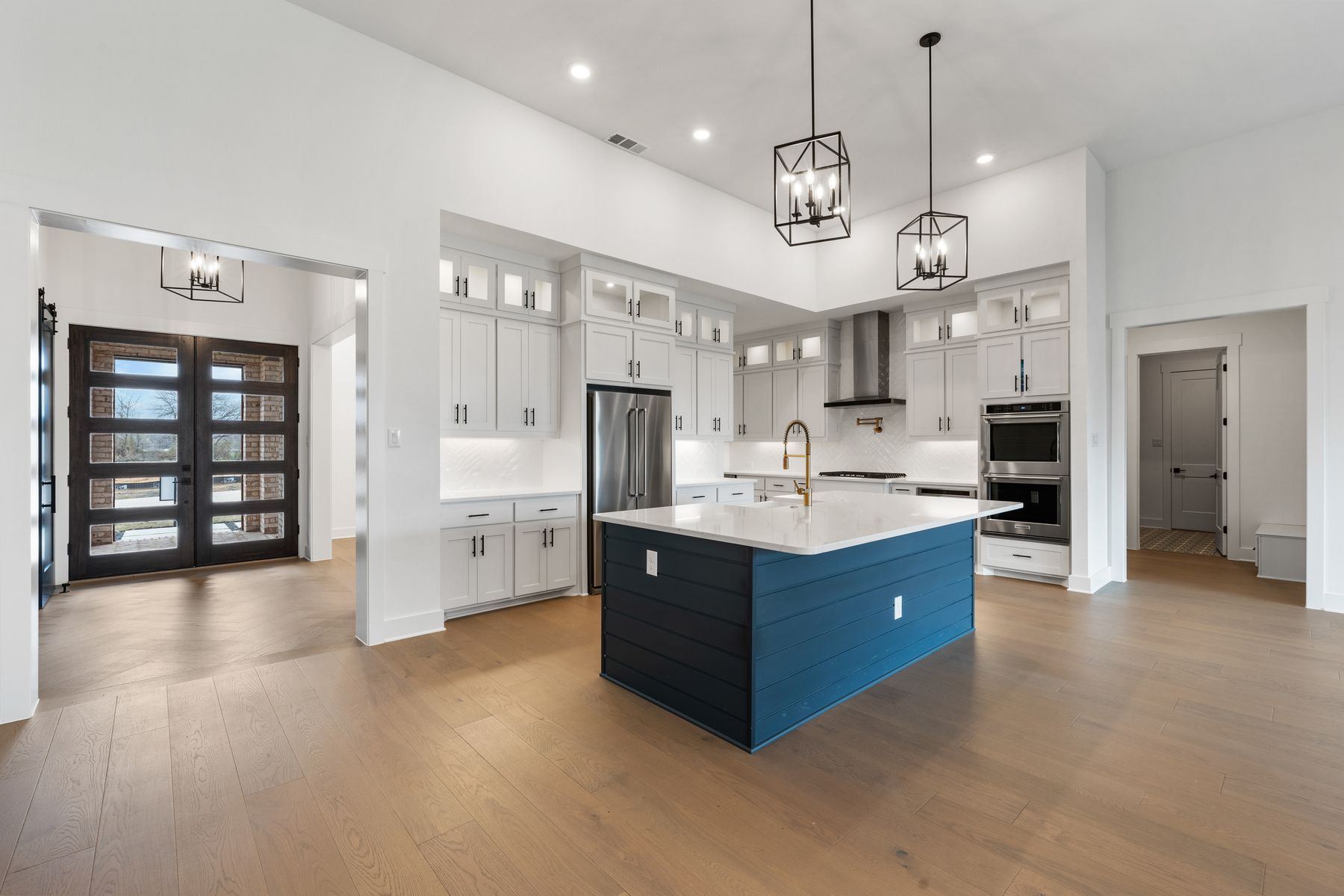 The kitchen has gorgeous white cabinetry with black hardware.