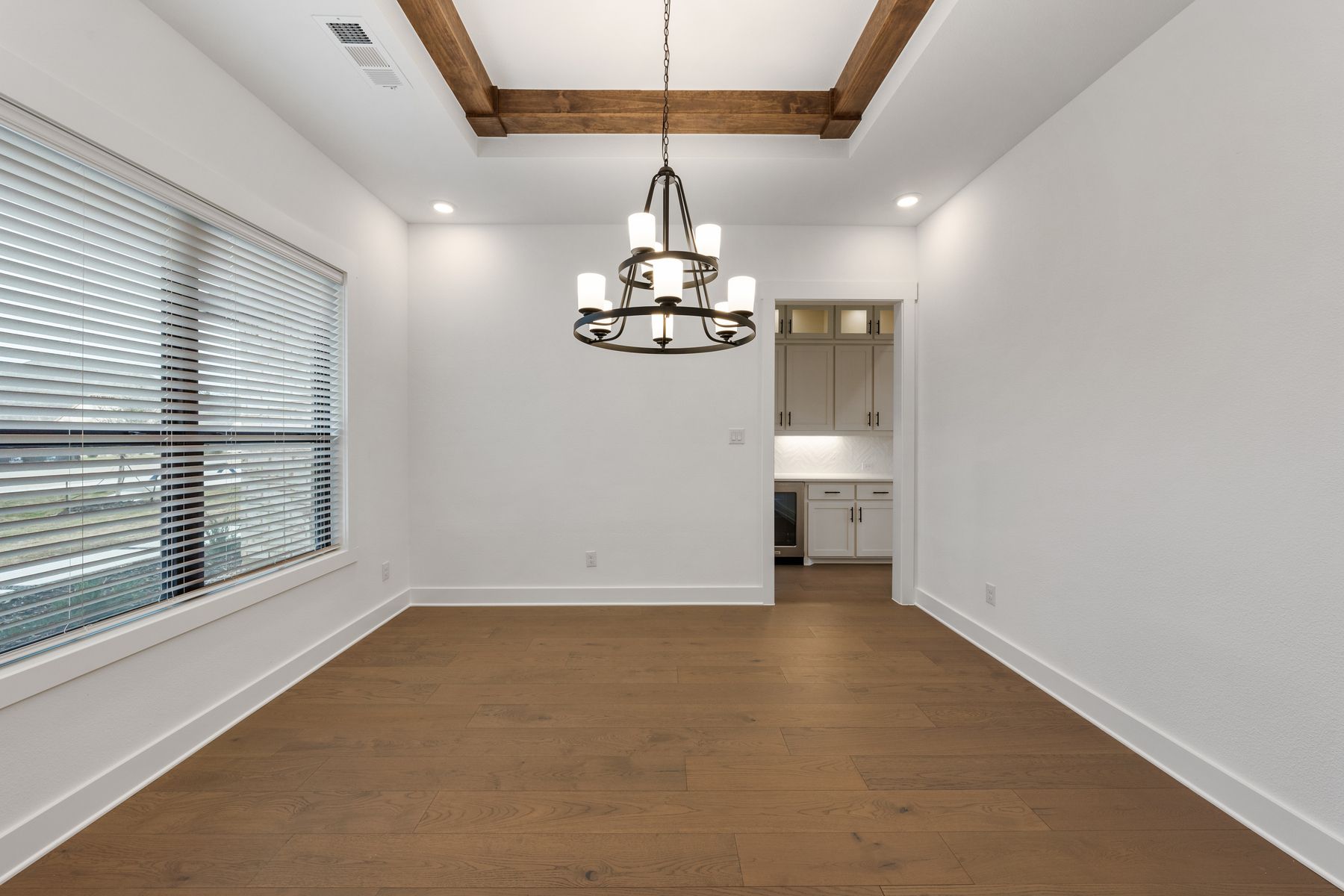 The formal dining room sits right off of the kitchen and has a large window.