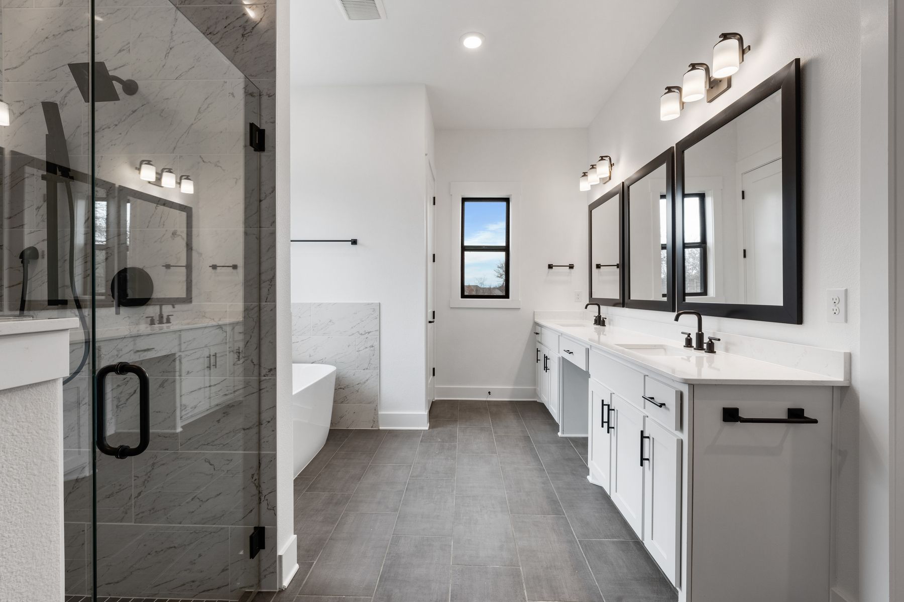 The gorgeous master bathroom has a giant vanity space that has two sinks and vanity space.