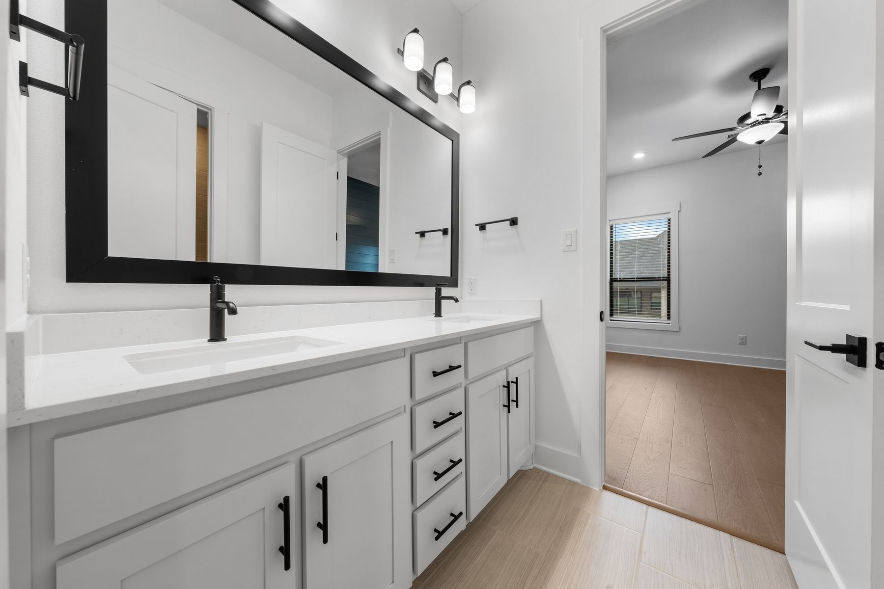 The secondary bathroom has a large, dual-sink vanity with plenty of cabinet space.
