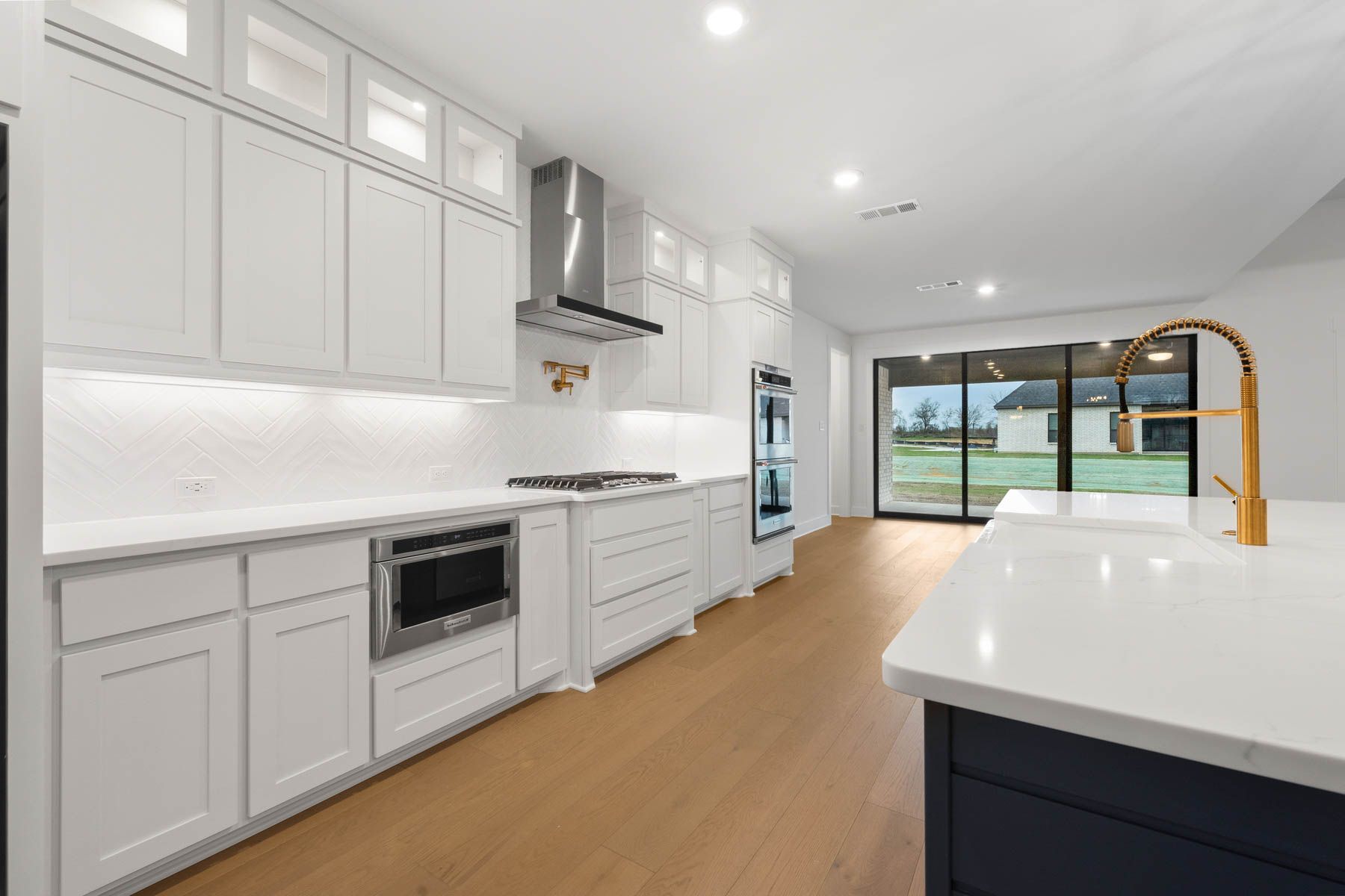 The kitchen has stainless-steel KitchenAid appliances.