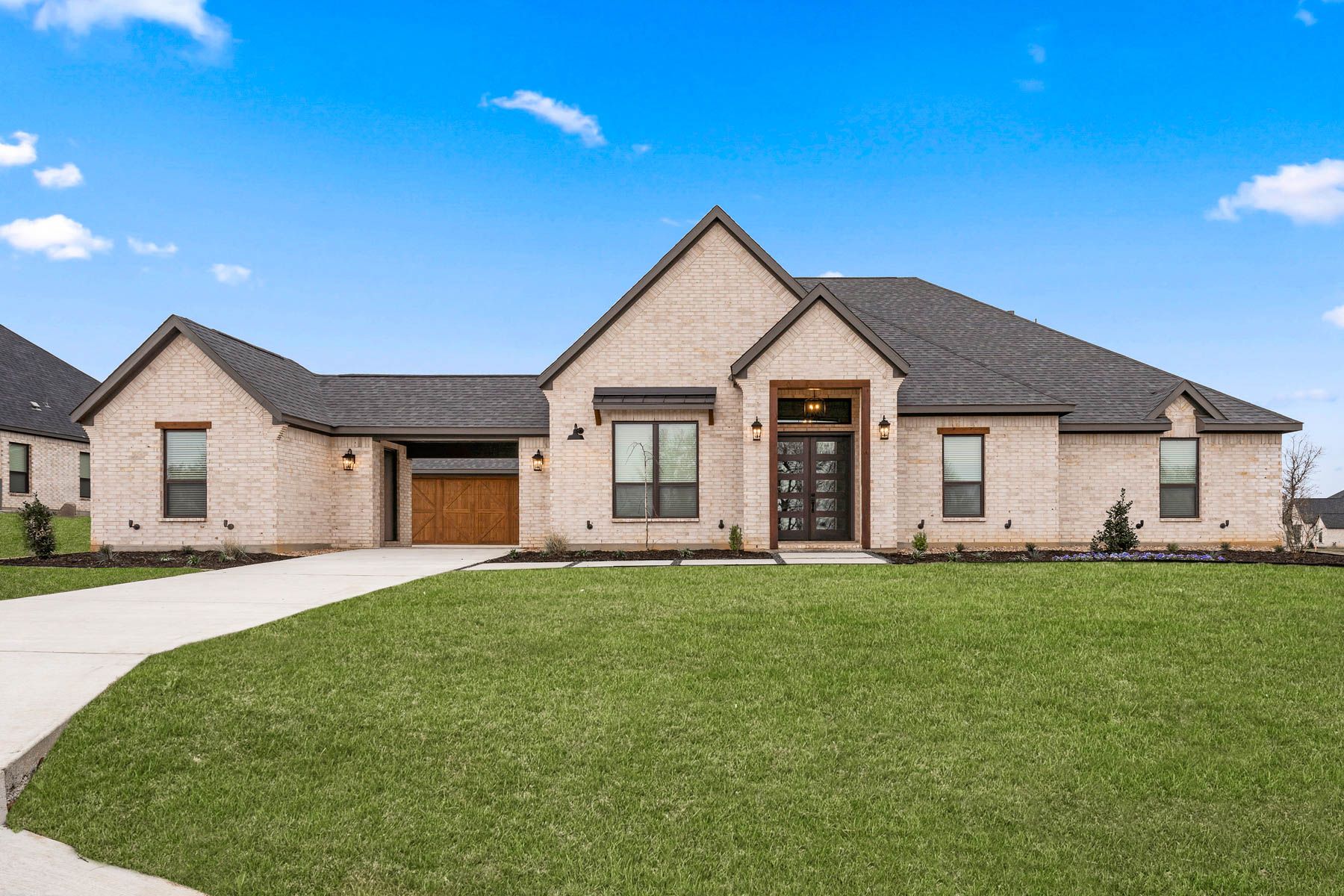 The Garza is a beautiful, one-story brick home with wood accents.