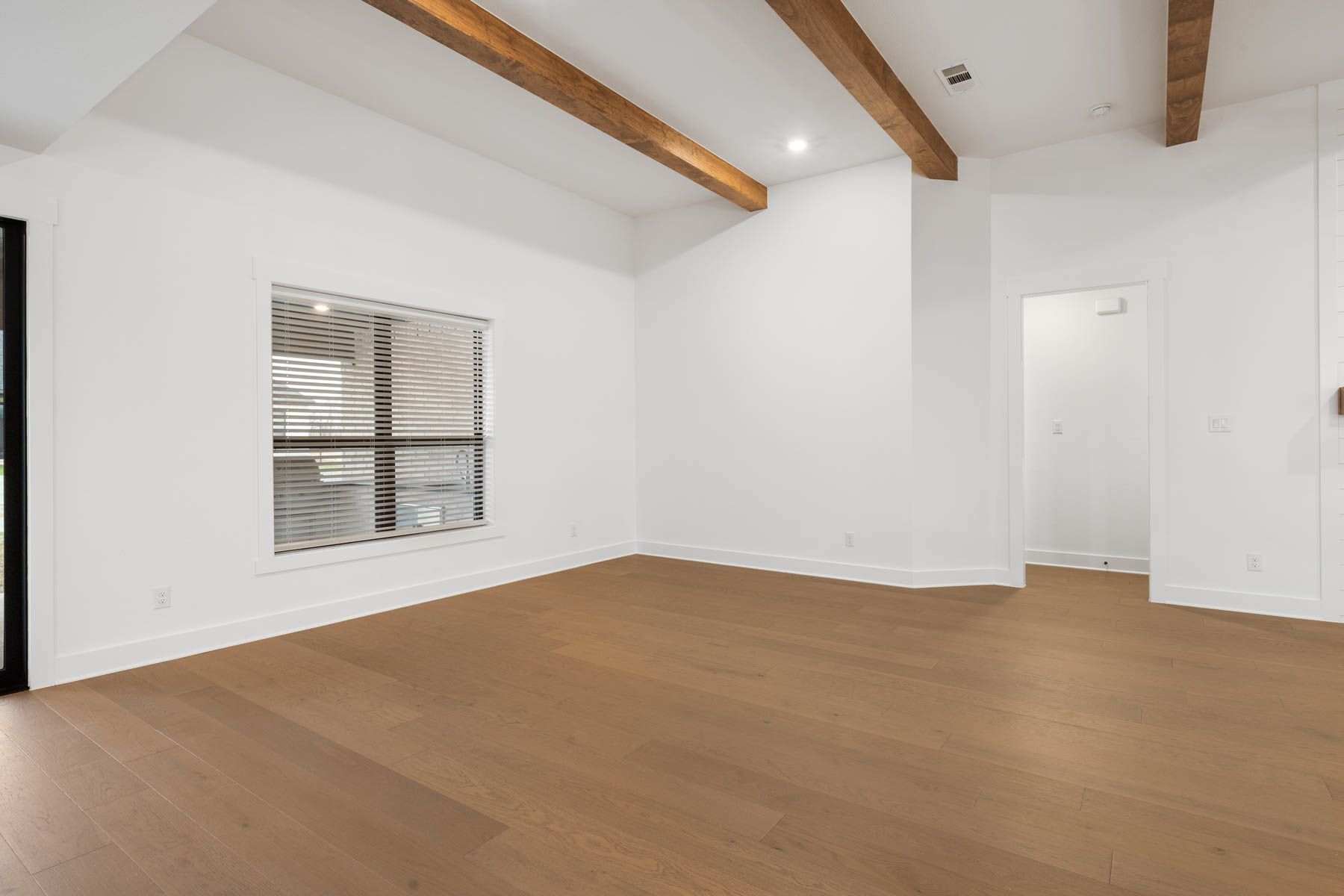 The spacious family room has a large window that lets in natural light.