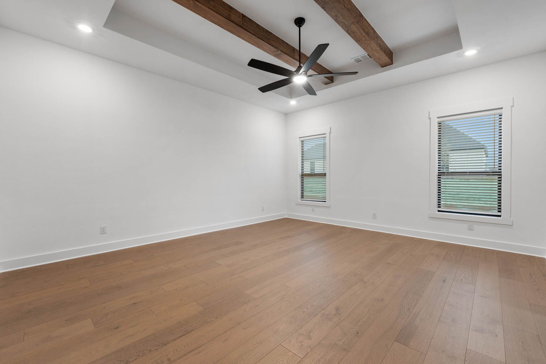 The peaceful master bedroom has two large windows that let in great, natural light.