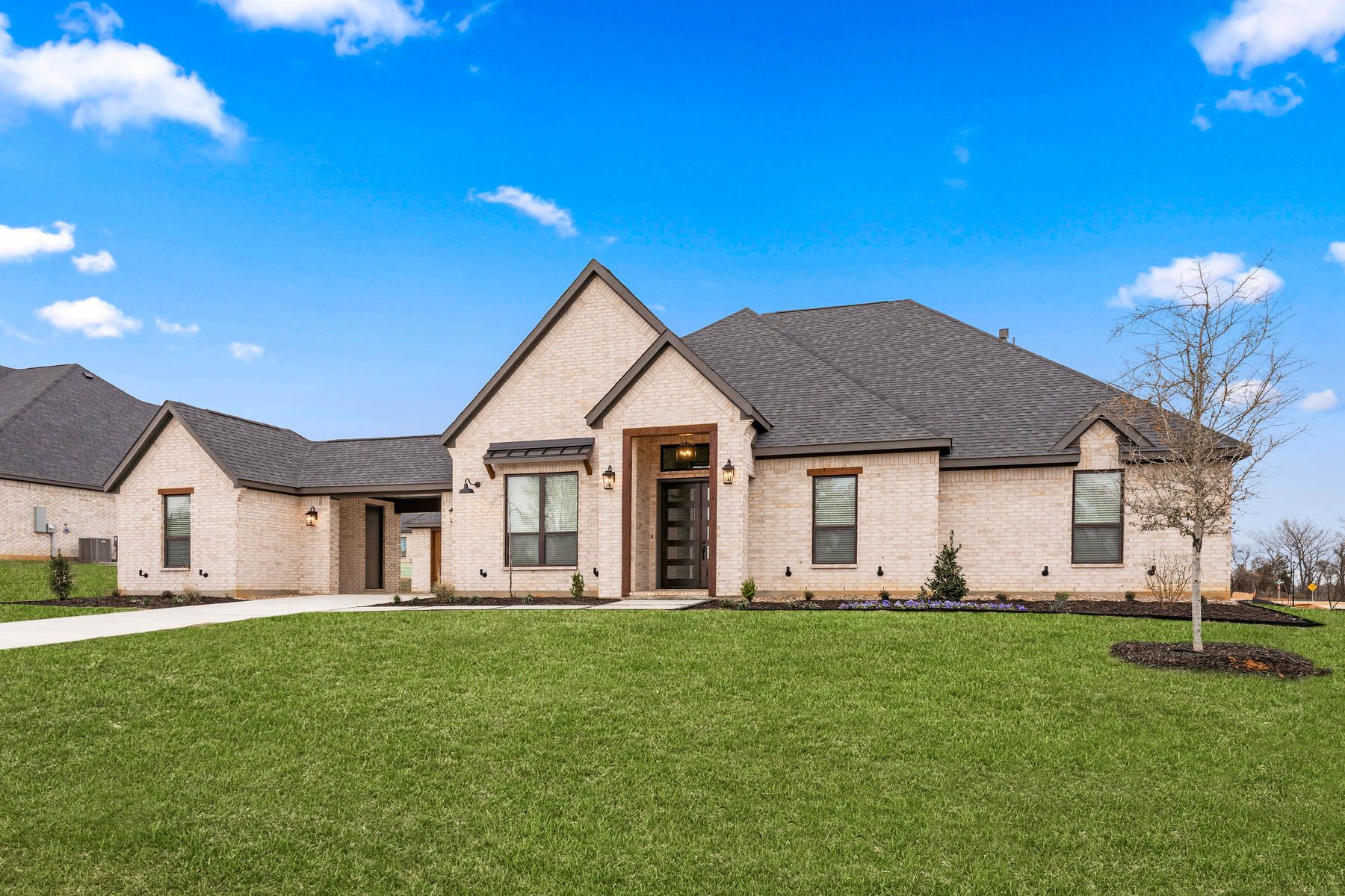 The Garza is a beautiful, one-story brick home with wood accents.