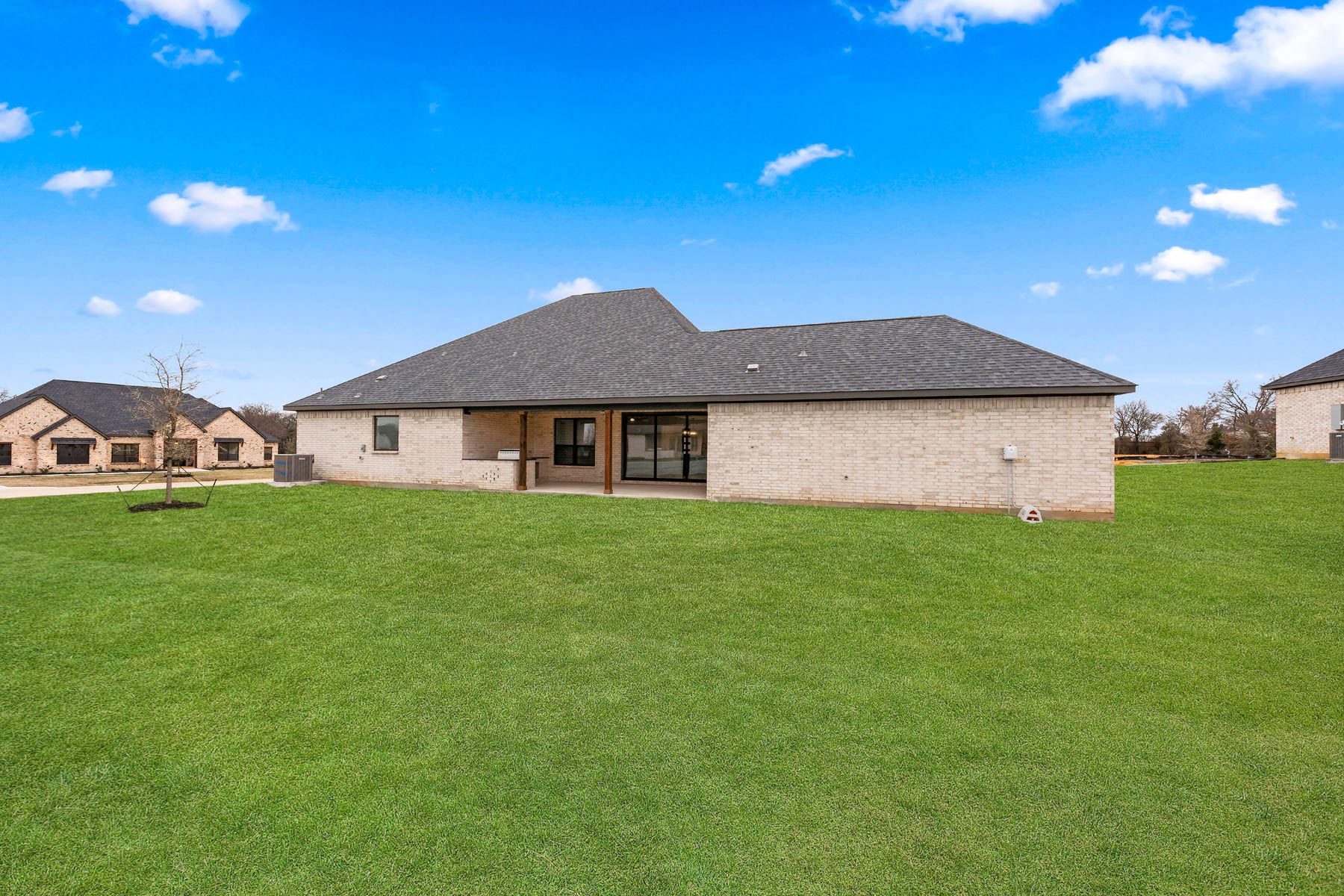 The Garza has a gorgeous back yard that includes a covered patio with an outdoor kitchen.