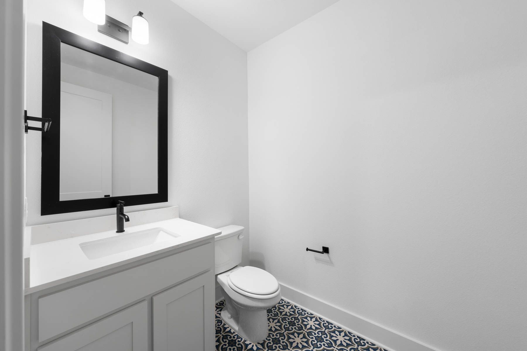 The secondary bathroom has a large vanity with plenty of cabinet space.