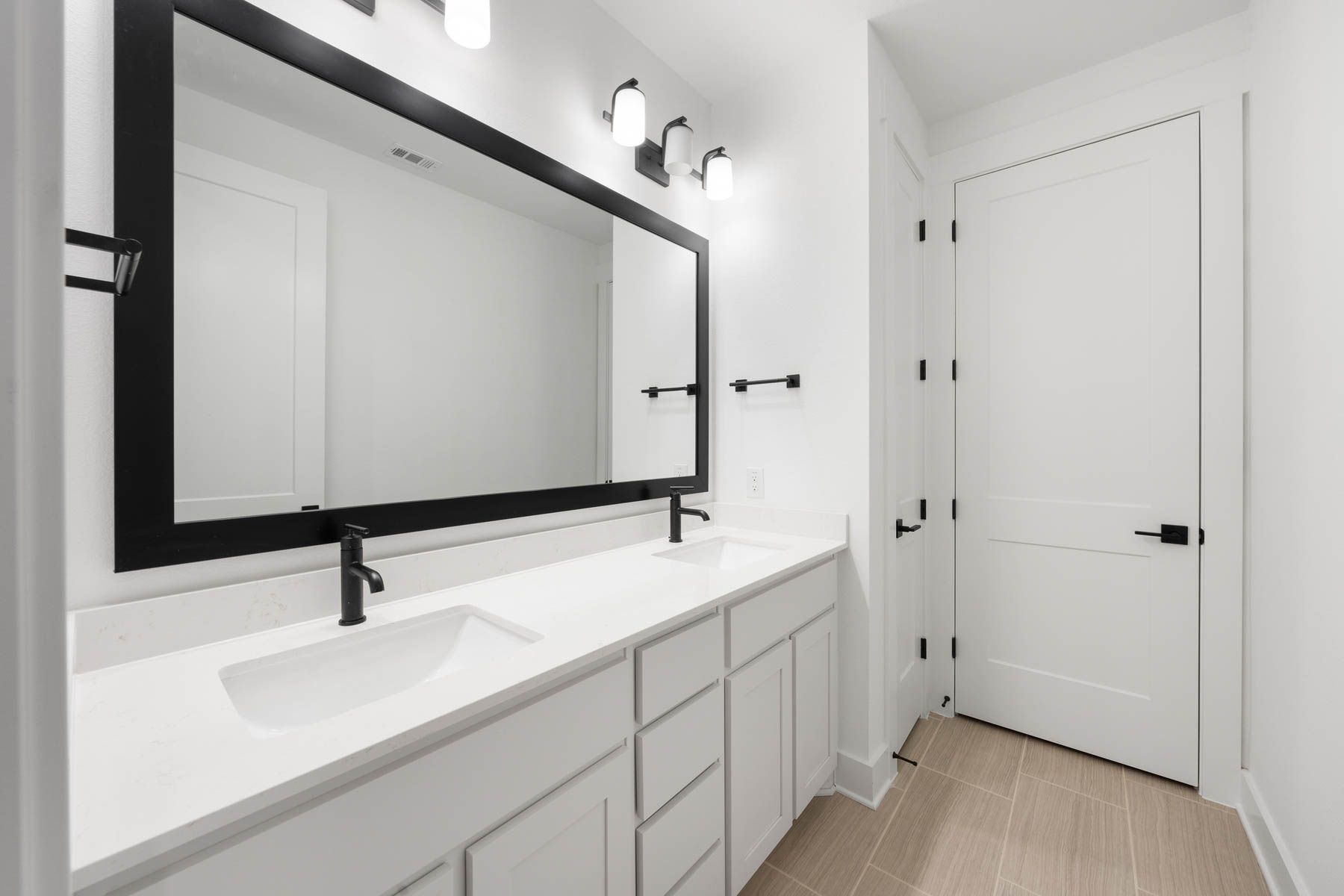 The secondary bathroom has a large vanity with plenty of cabinet space.