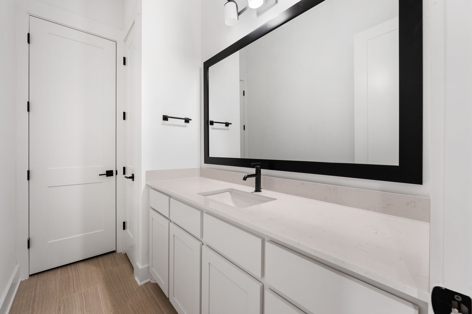 The secondary bathroom has a large vanity with plenty of cabinet space.