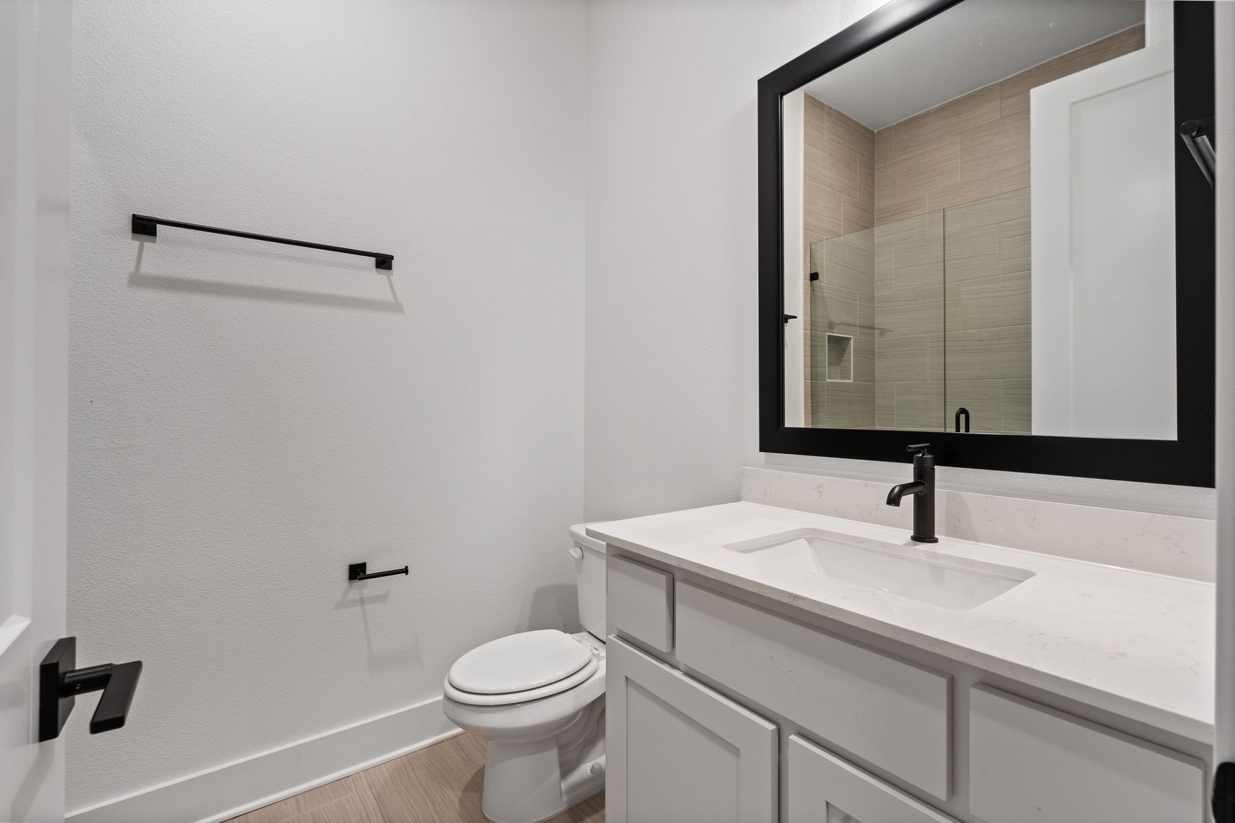 The secondary bathroom has a large vanity with plenty of cabinet space.