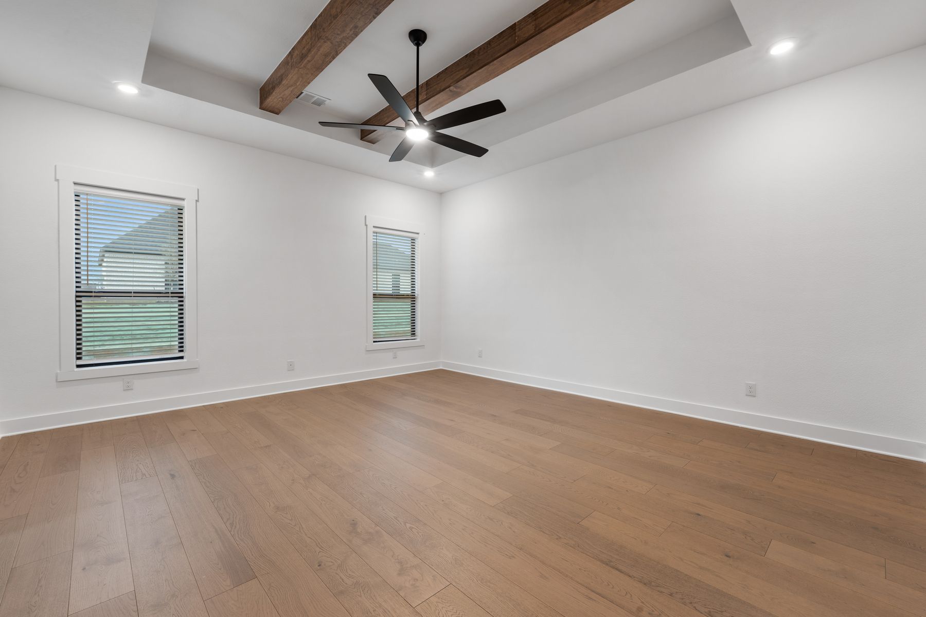 The peaceful master bedroom has two large windows that let in great, natural light.