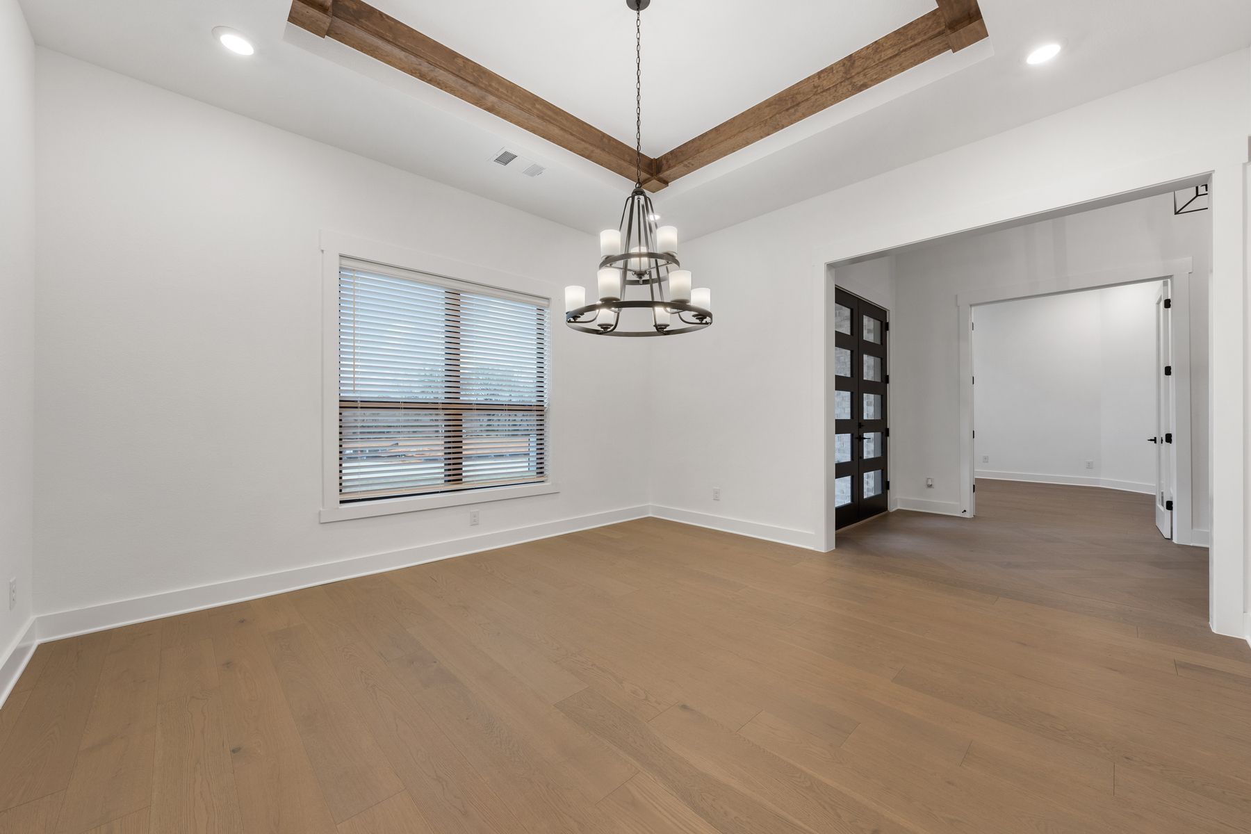 The formal dining room sits right off of the kitchen and has a large window.