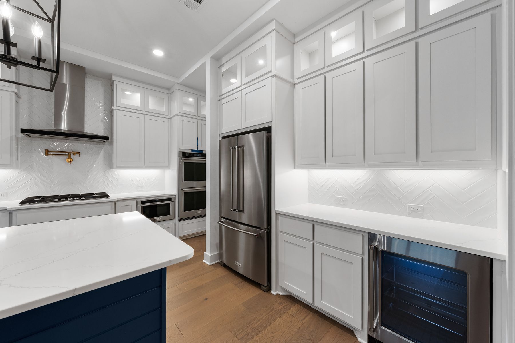 The kitchen has goregous white tile backsplash.