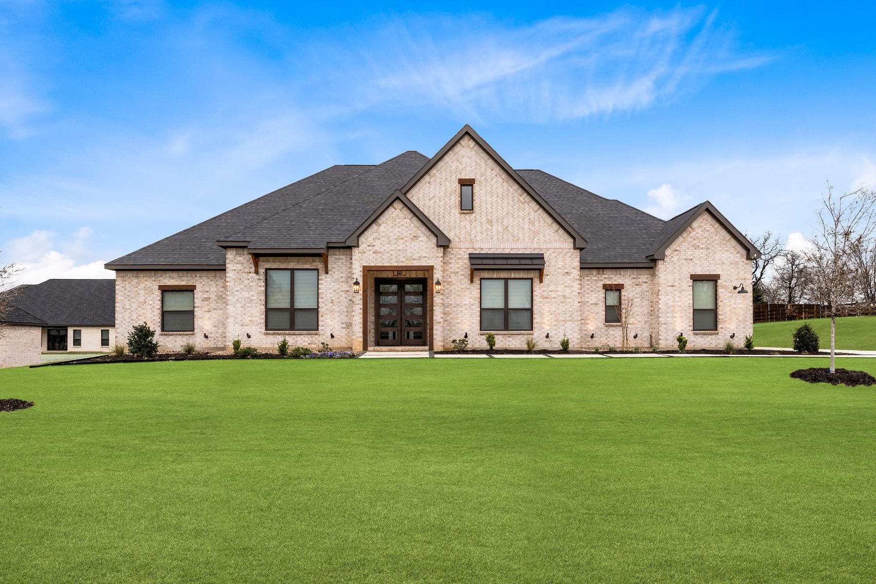 The Stratton II is a beautiful, one-story brick home with wood accents.