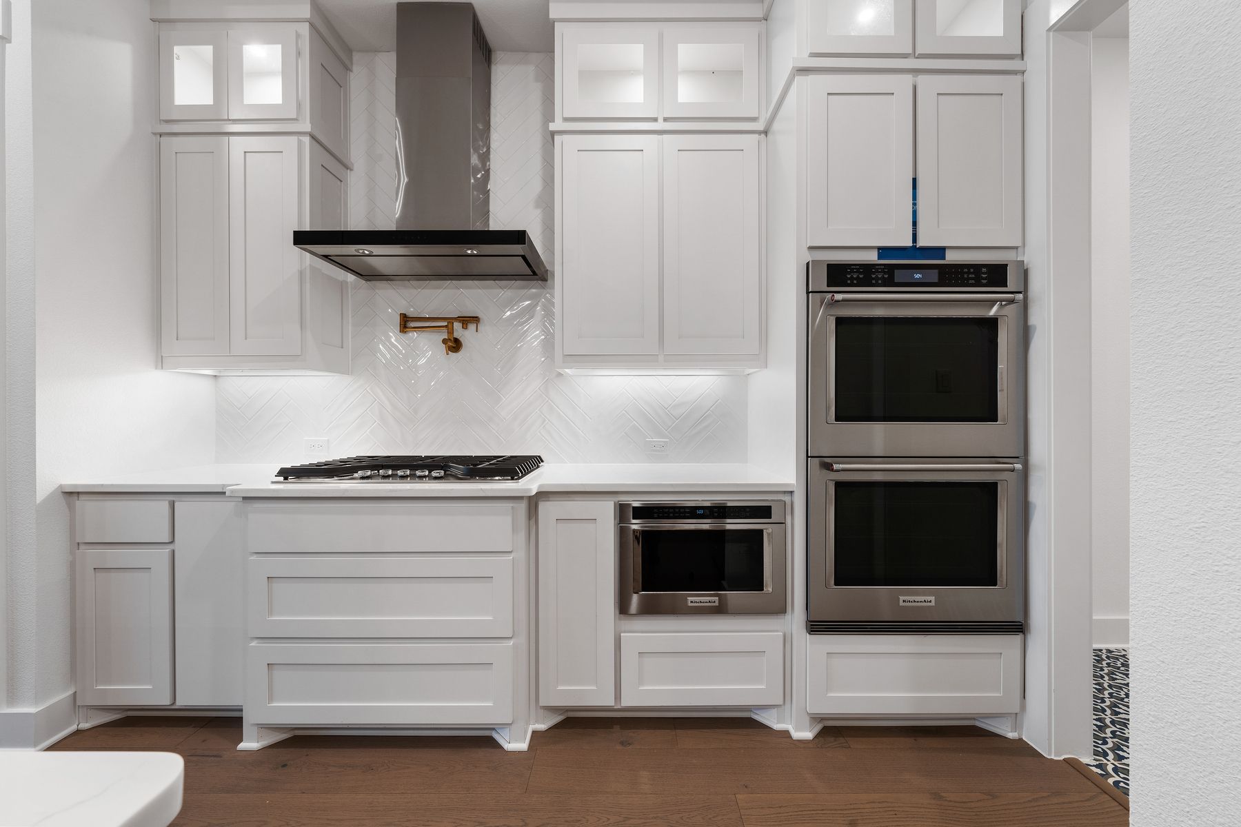 The kitchen has stainless-steel KitchenAid appliances.