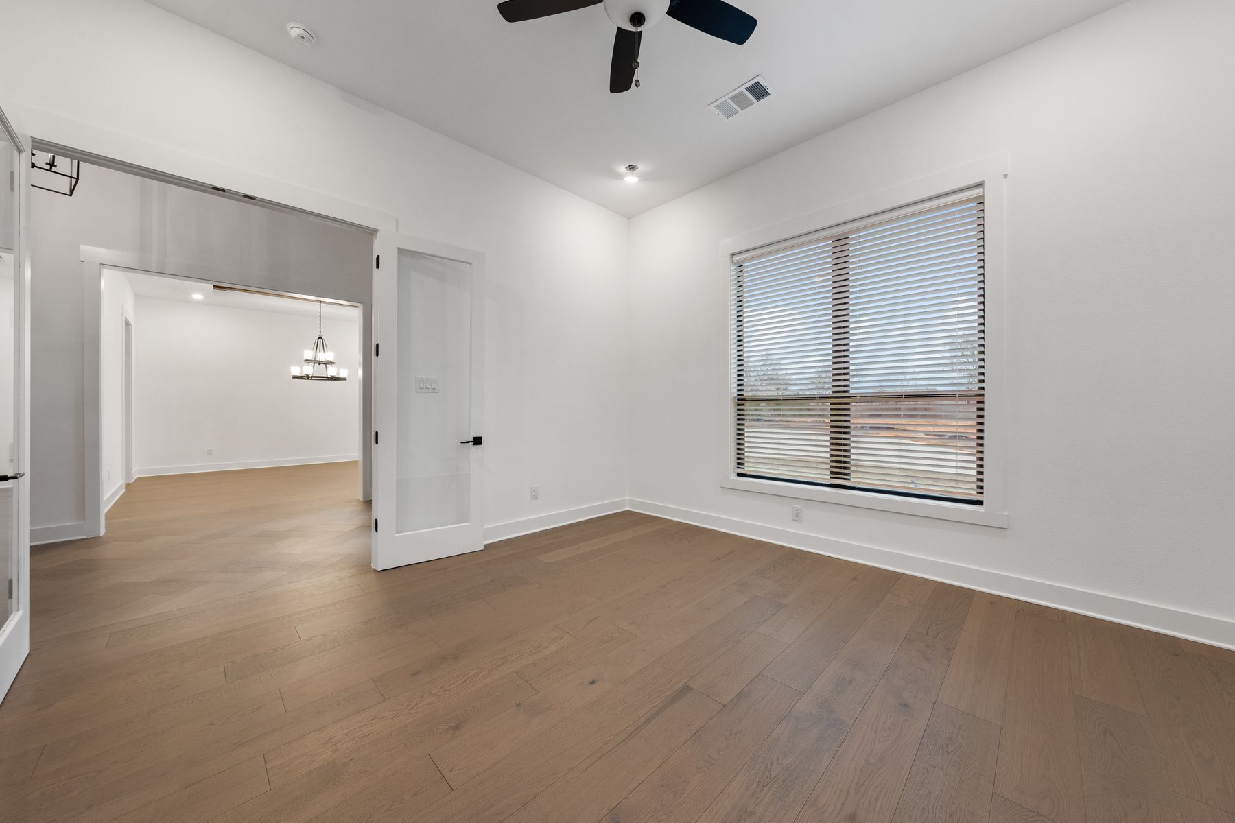 The flex room is located right off of the foyer and has a large window.