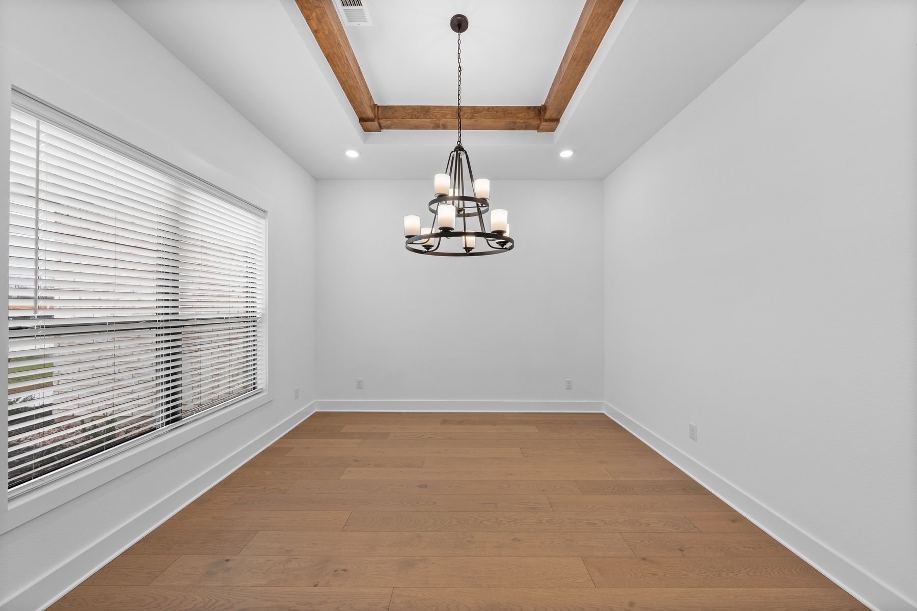 The formal dining room sits right off of the kitchen and has a large window.