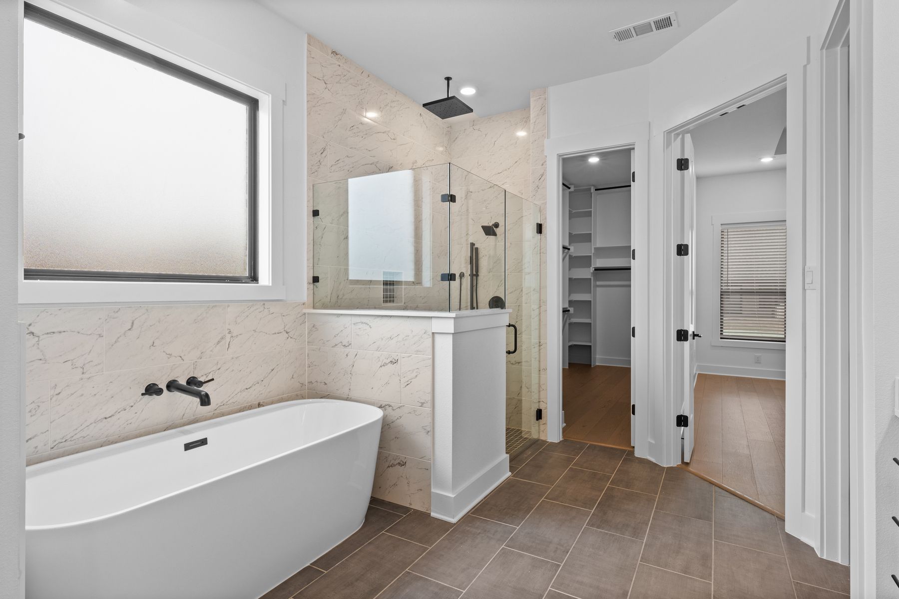 The gorgeous master bathroom has a giant vanity space that has two sinks and vanity space.