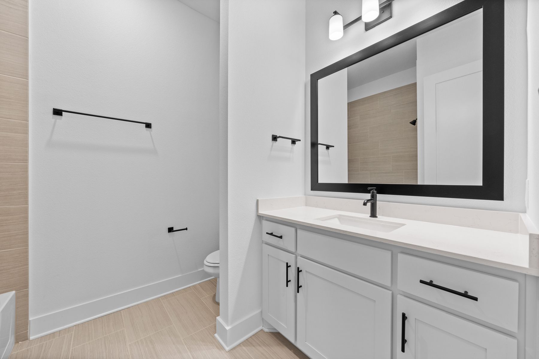 The secondary bathroom has a large vanity with plenty of cabinet space.