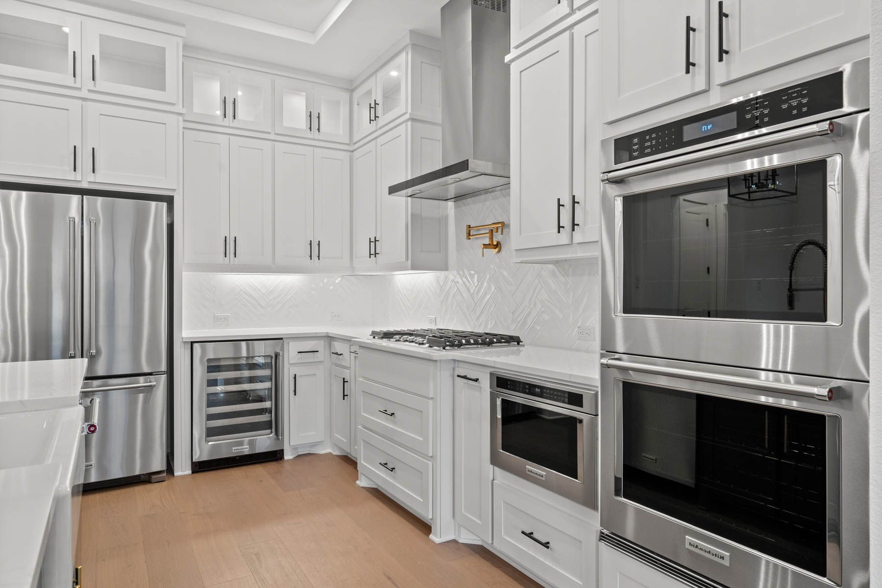 The kitchen has stainless-steel KitchenAid appliances.