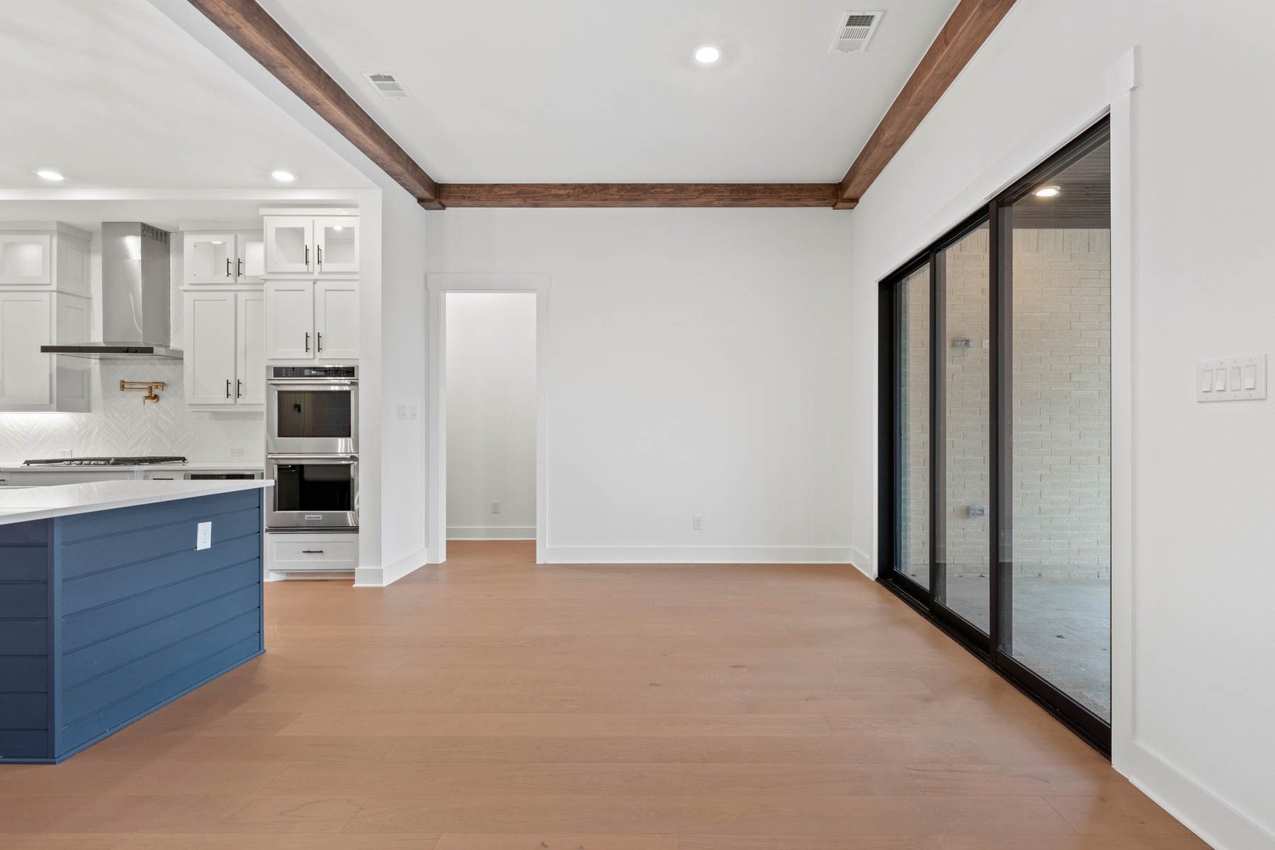 The open breakfast area has plenty of natural light from the sliding back doors.