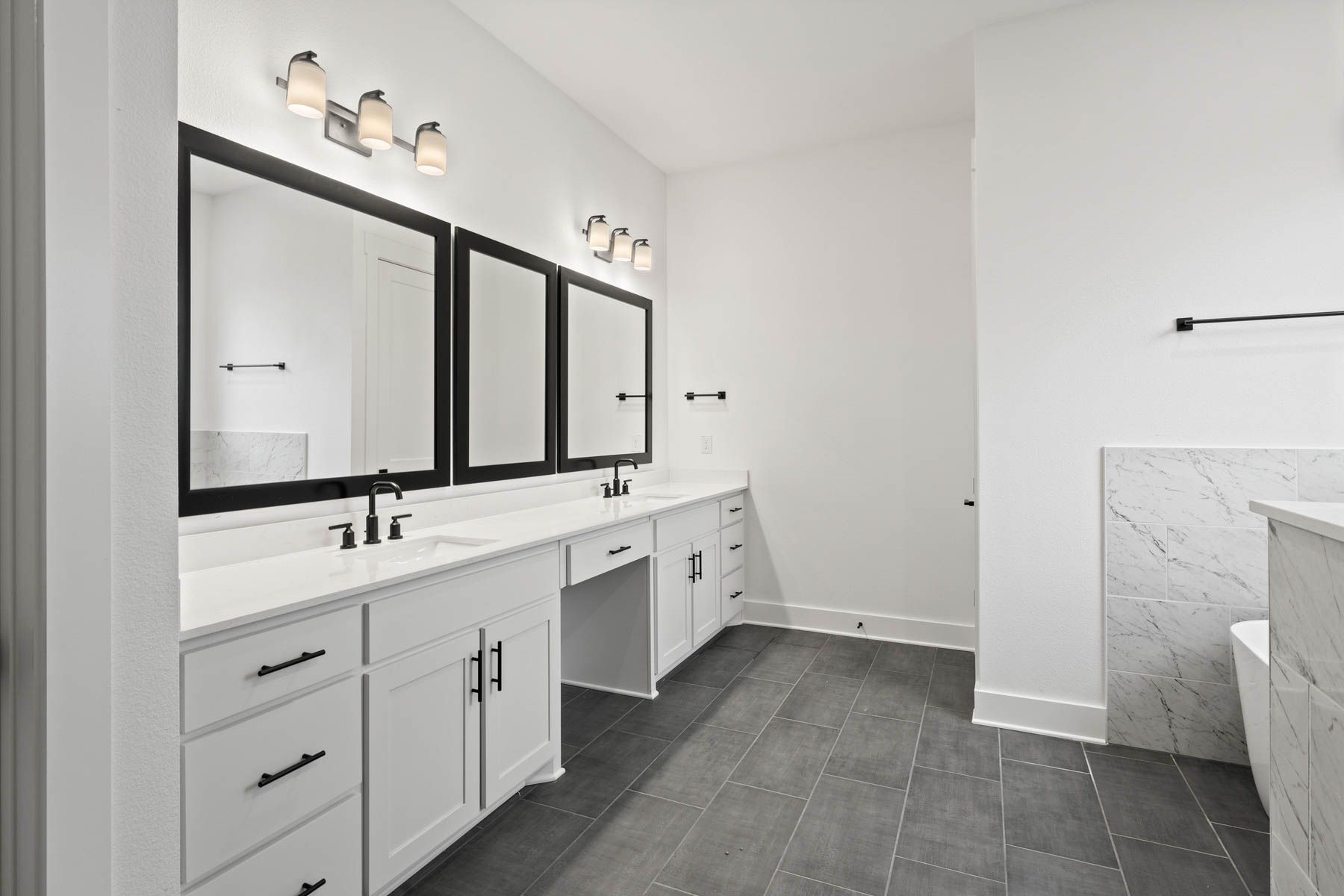 The gorgeous master bathroom has a large glass, walk-in shower and tub.