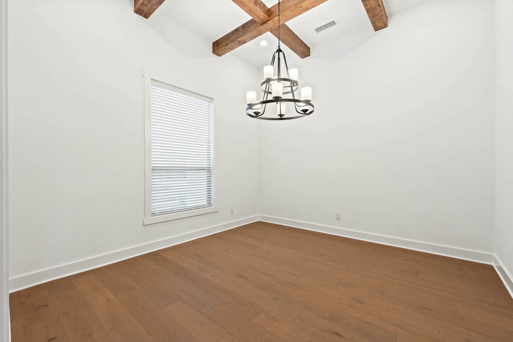 The formal dining room sits right off of the kitchen and has a large window.