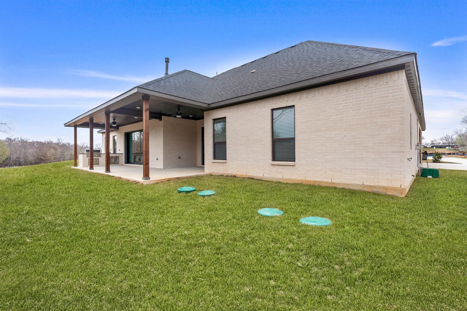 The Bradley II has a gorgeous back yard that includes a covered patio with an outdoor kitchen.