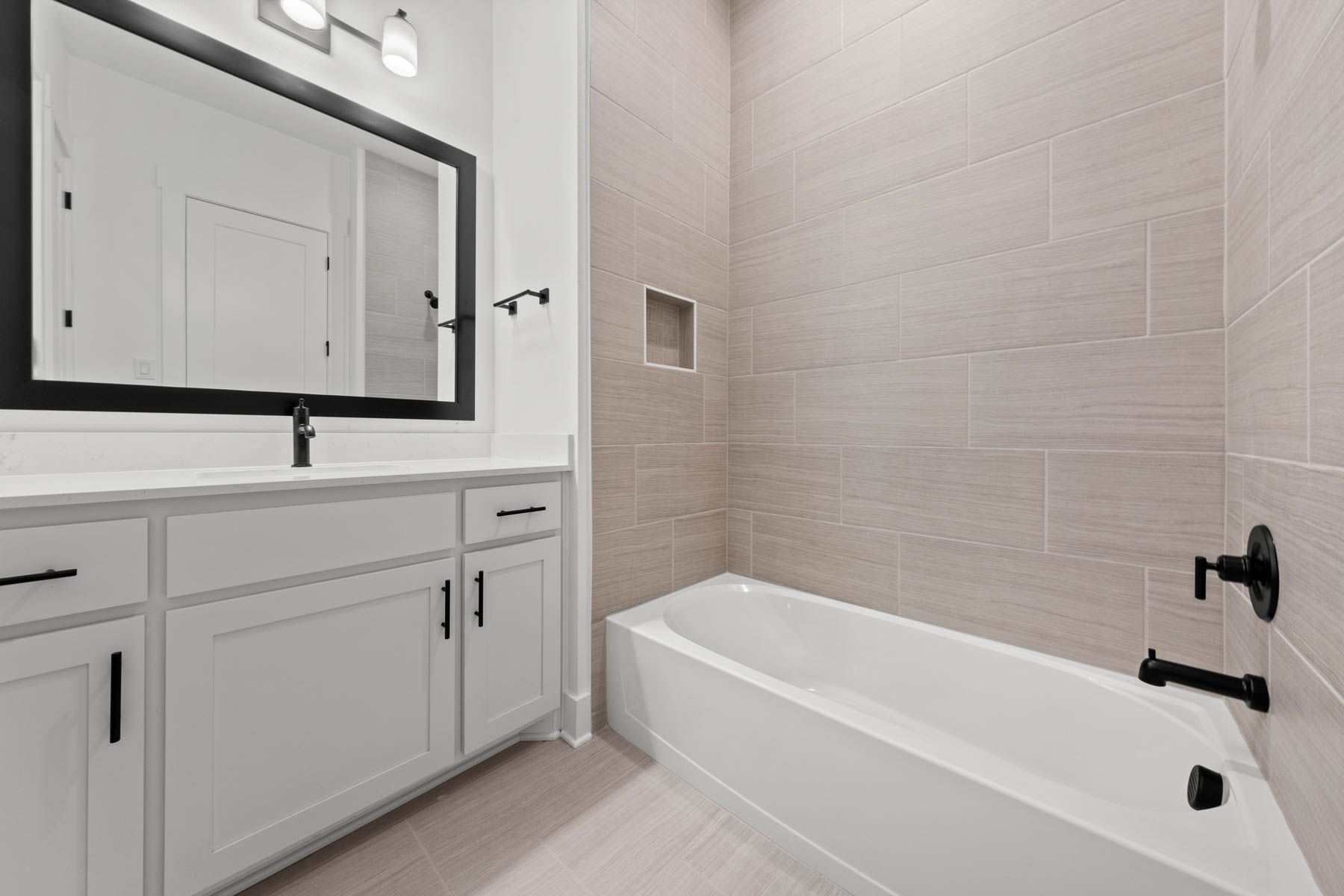 The secondary bathroom has a large vanity with plenty of cabinet space and a shower-tub combo.