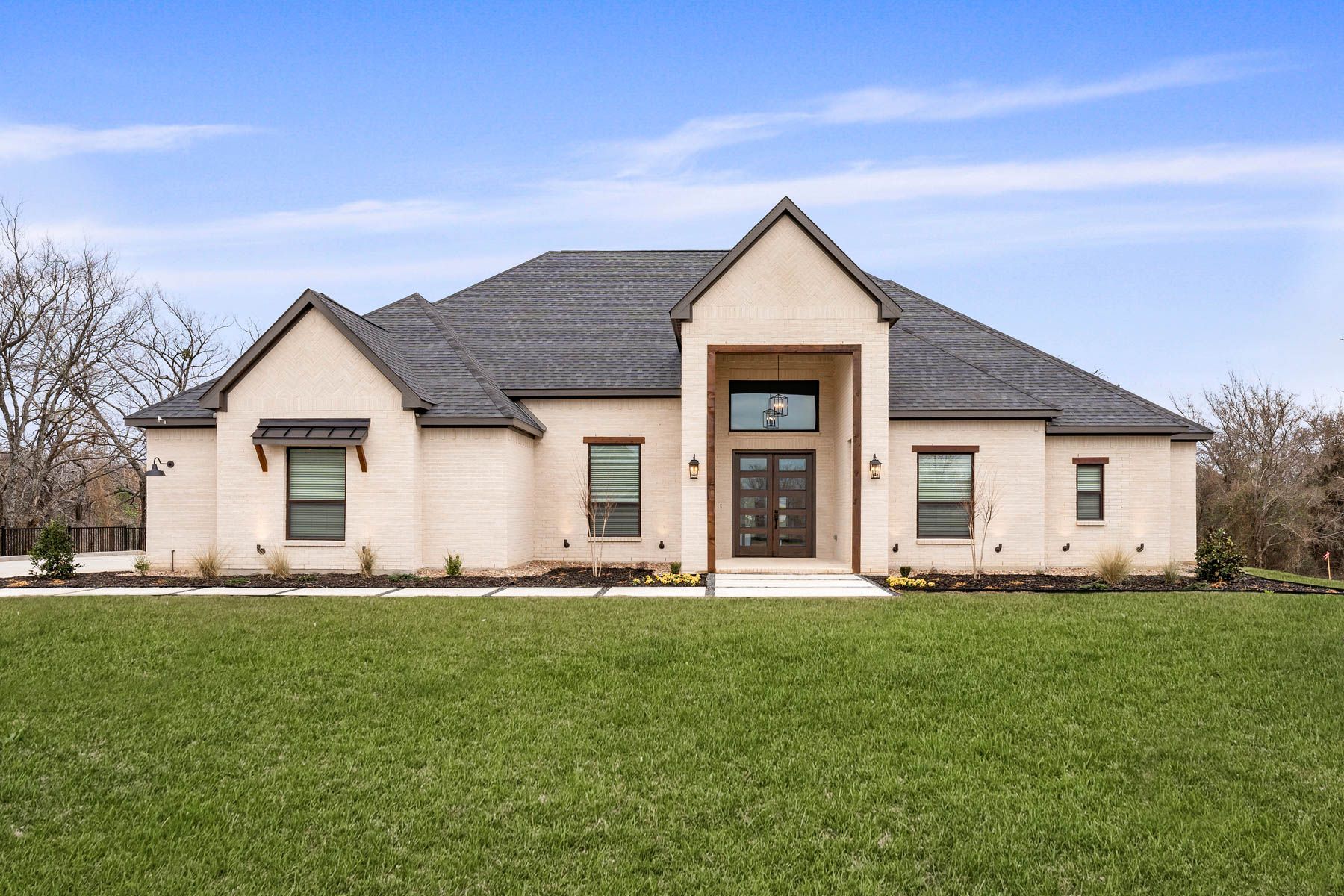 The Timberline II is a beautiful, one-story brick home with wood accents.