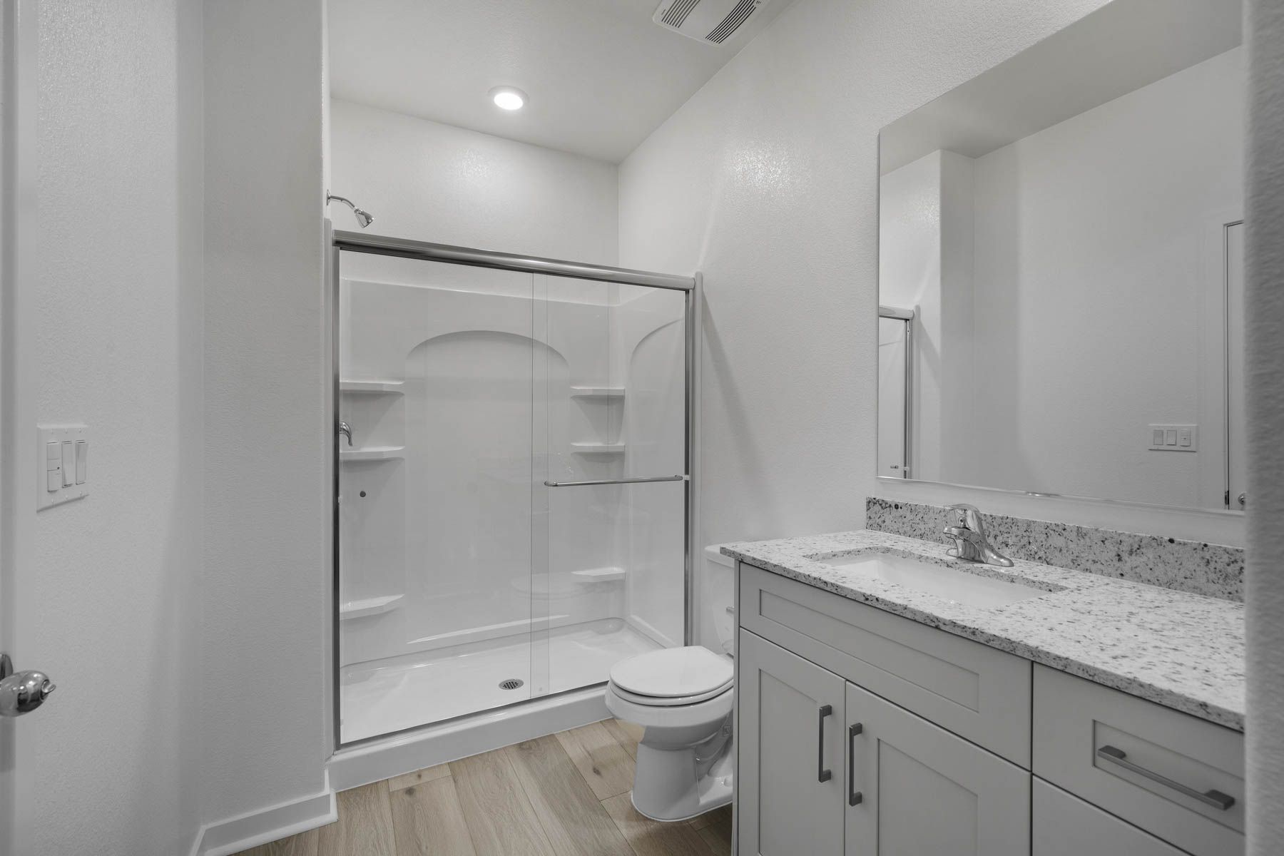 The master bathroom has a large vanity and step in shower. 