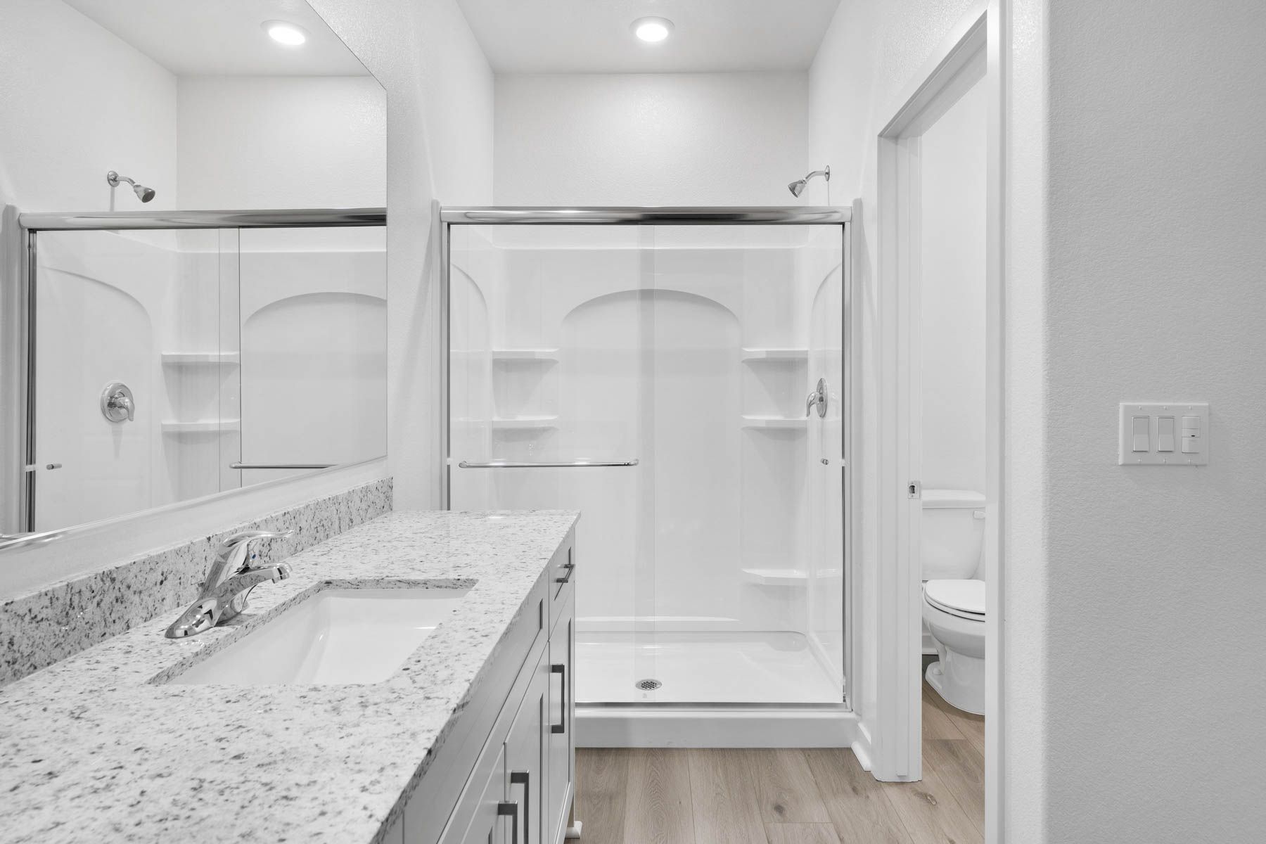 The master bathroom has a large vanity.