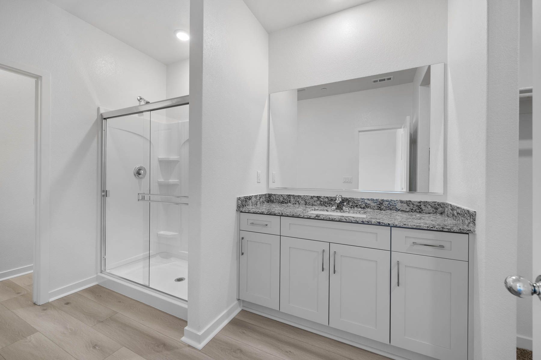 The master bathroom has a large vanity.