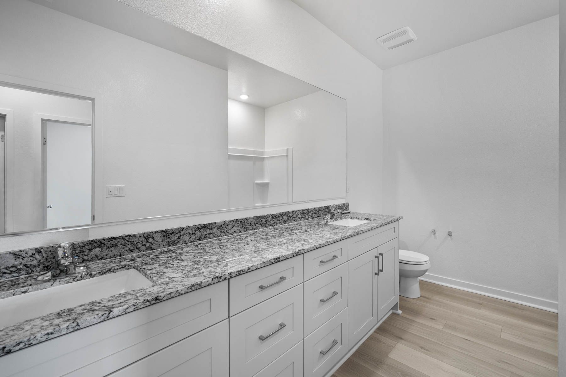 The secondary bathroom has a dual sink vanity and a tub/shower combo.