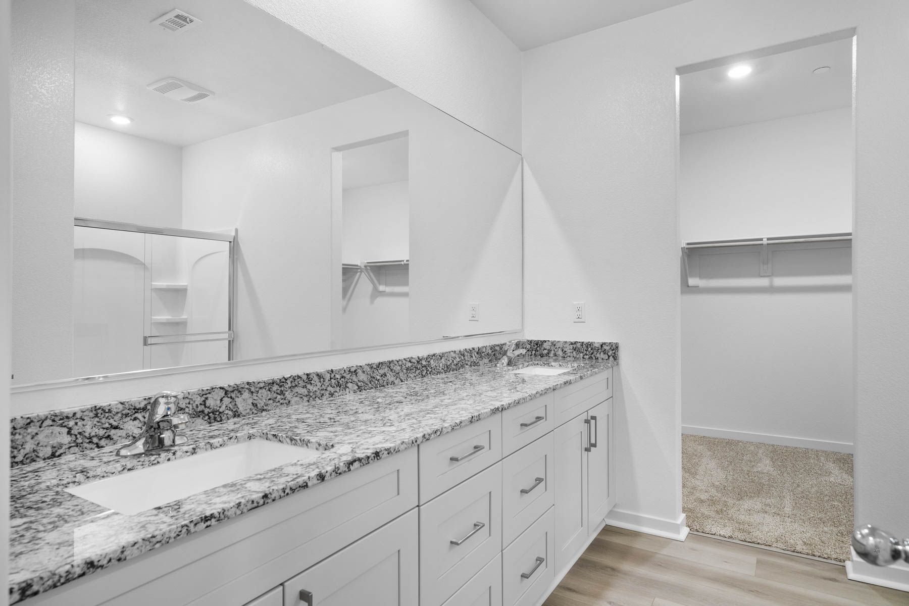 The master bathroom has a dual sink vanity.