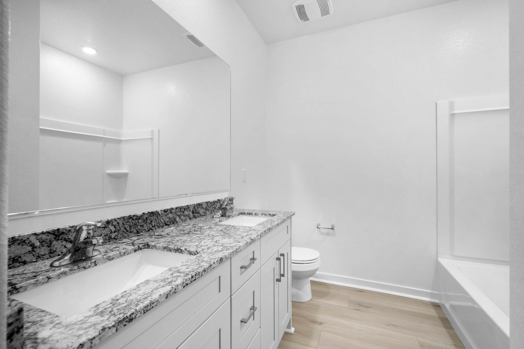 The master bathroom has a large vanity.