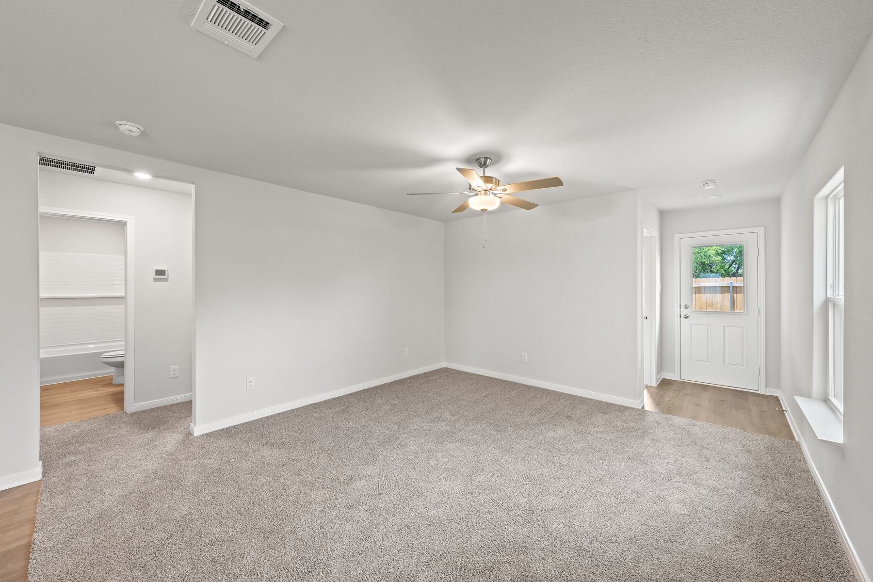 The family room of the Cedar is spacious and has a window that lets in great, natural light.