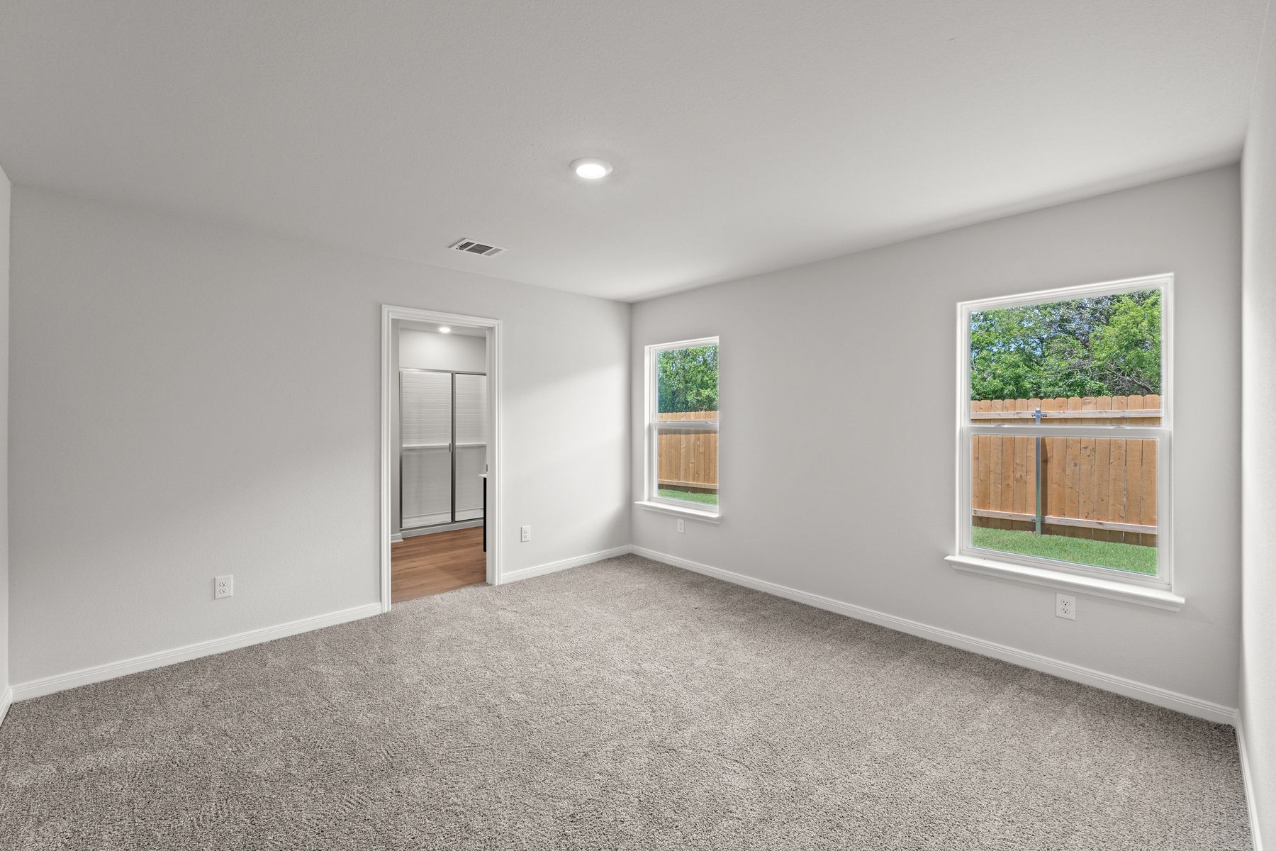 The master suite of the Cedar plan has a spacious bedroom, en-suite bathroom and large walk-in closet.