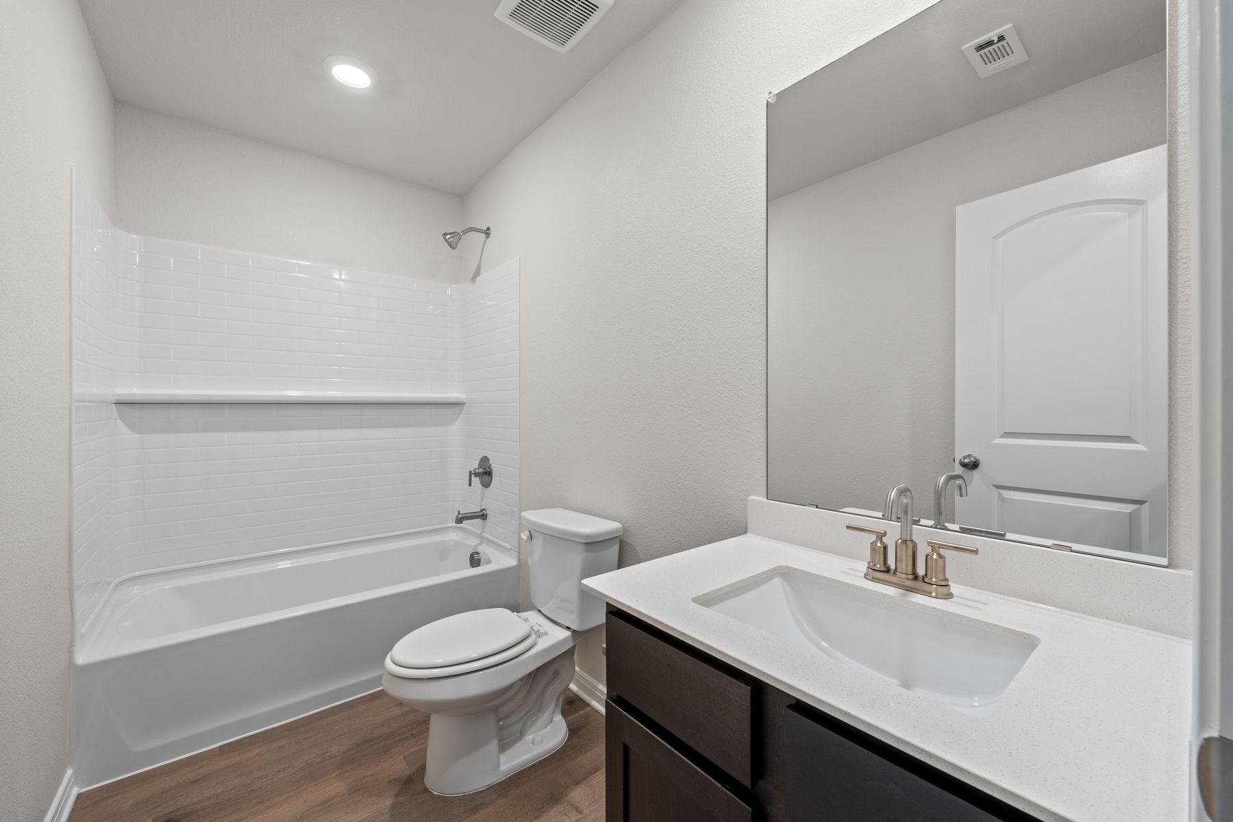 The secondary bathroom of the Cedar has a spacious vanity and shower-tub combo.