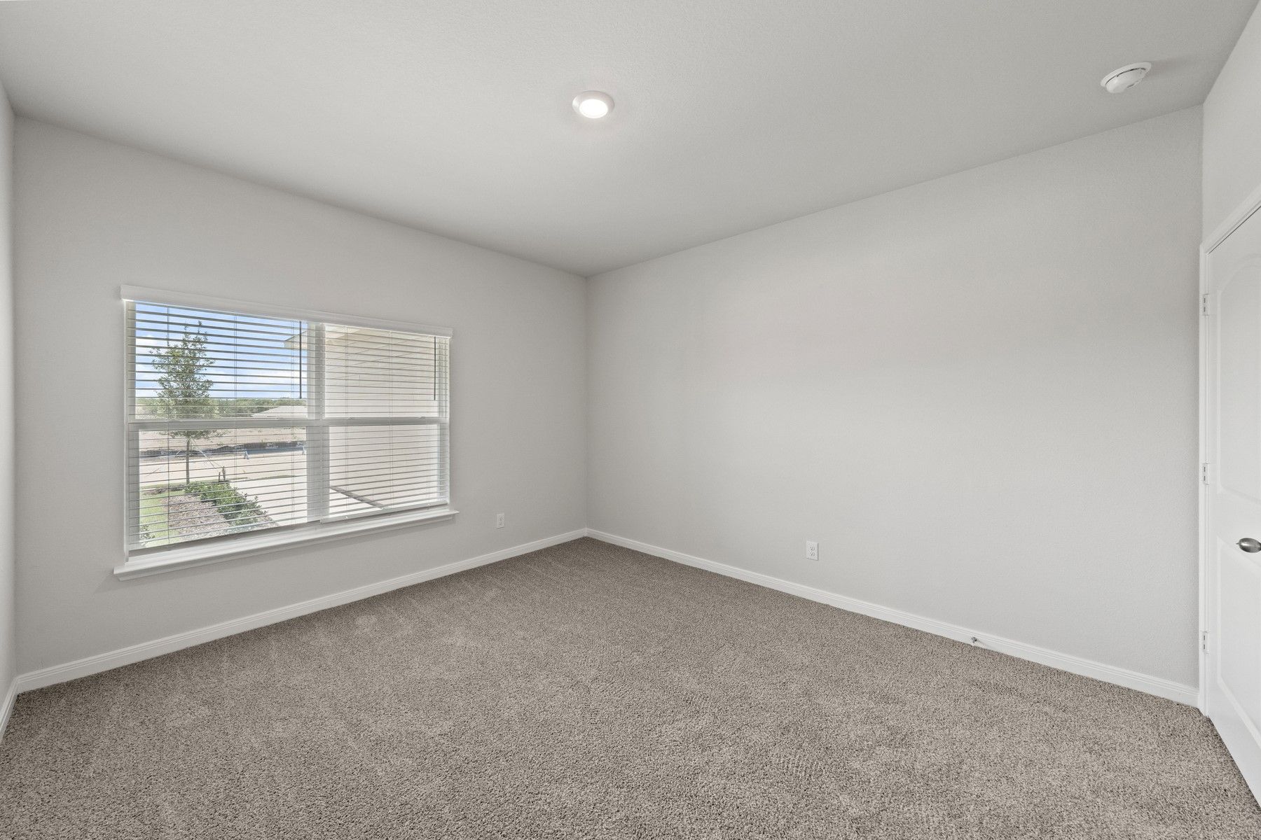 The master bedroom has a large window with wonderful natural light.